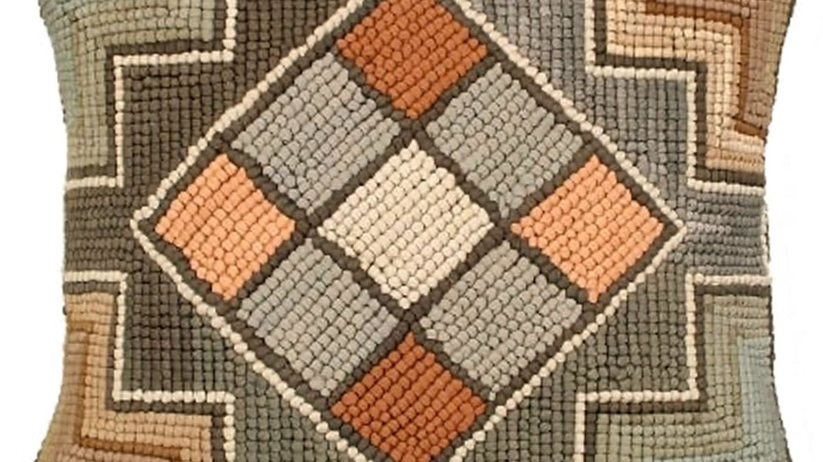 How to clean and care for needlepoint, hooked and embroidered pillows: a hand-hooked wool lodge pillow with raised loop texture