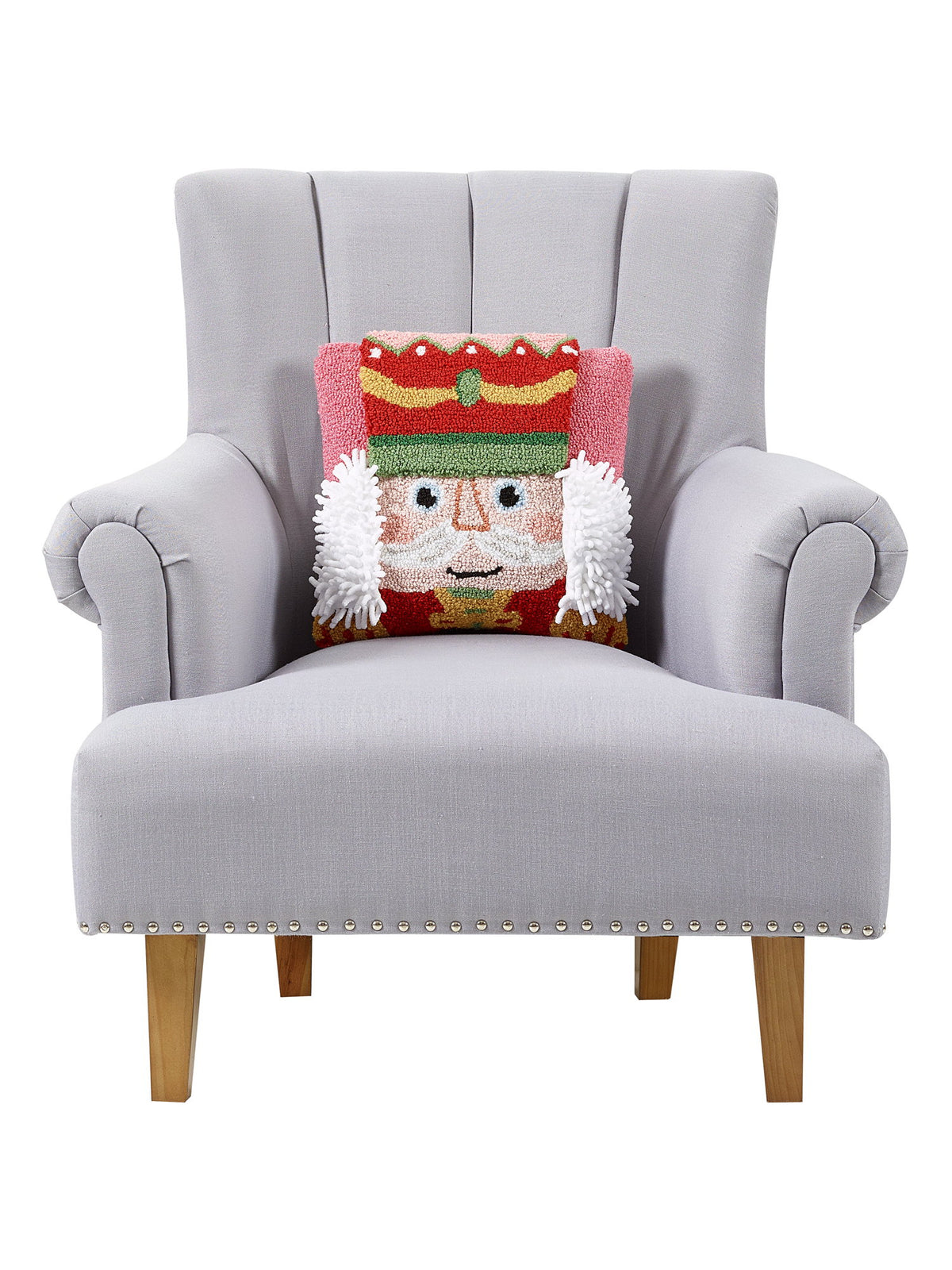 3D Nutcracker Hooked Christmas Throw Pillow on an armchair, showing the throw pillow at room scale, 14x14 inch