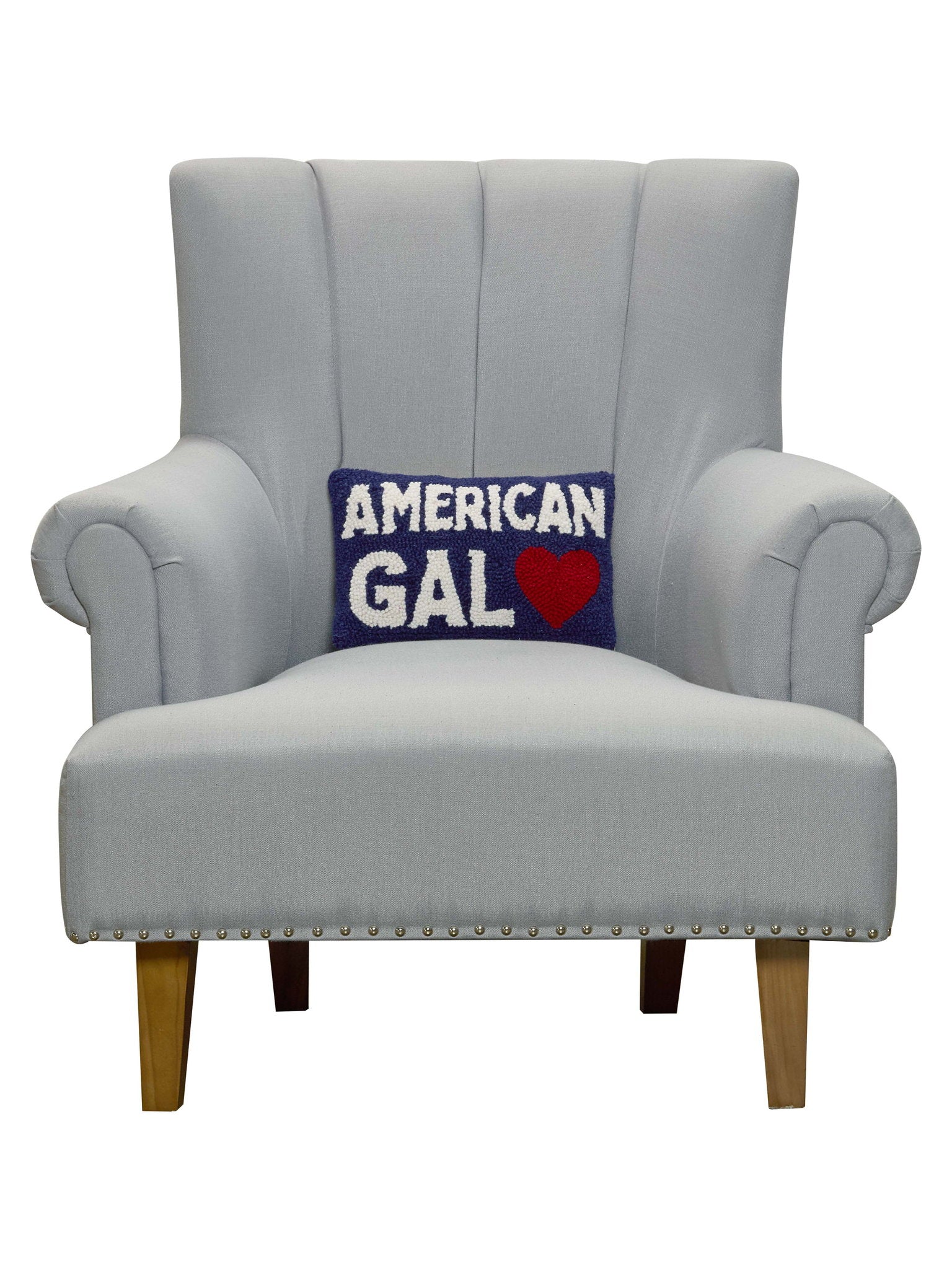 American Gal Hooked Wool Throw Pillow on an armchair, showing the throw pillow at room scale, 8x12 inch