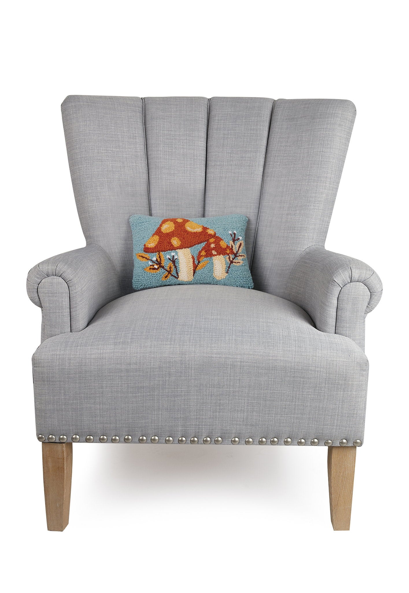 Autumn Mushroom with Leaves Hooked Wool Fall Harvest Throw Pillow on an armchair, showing the throw pillow at room scale, 8x12 inch