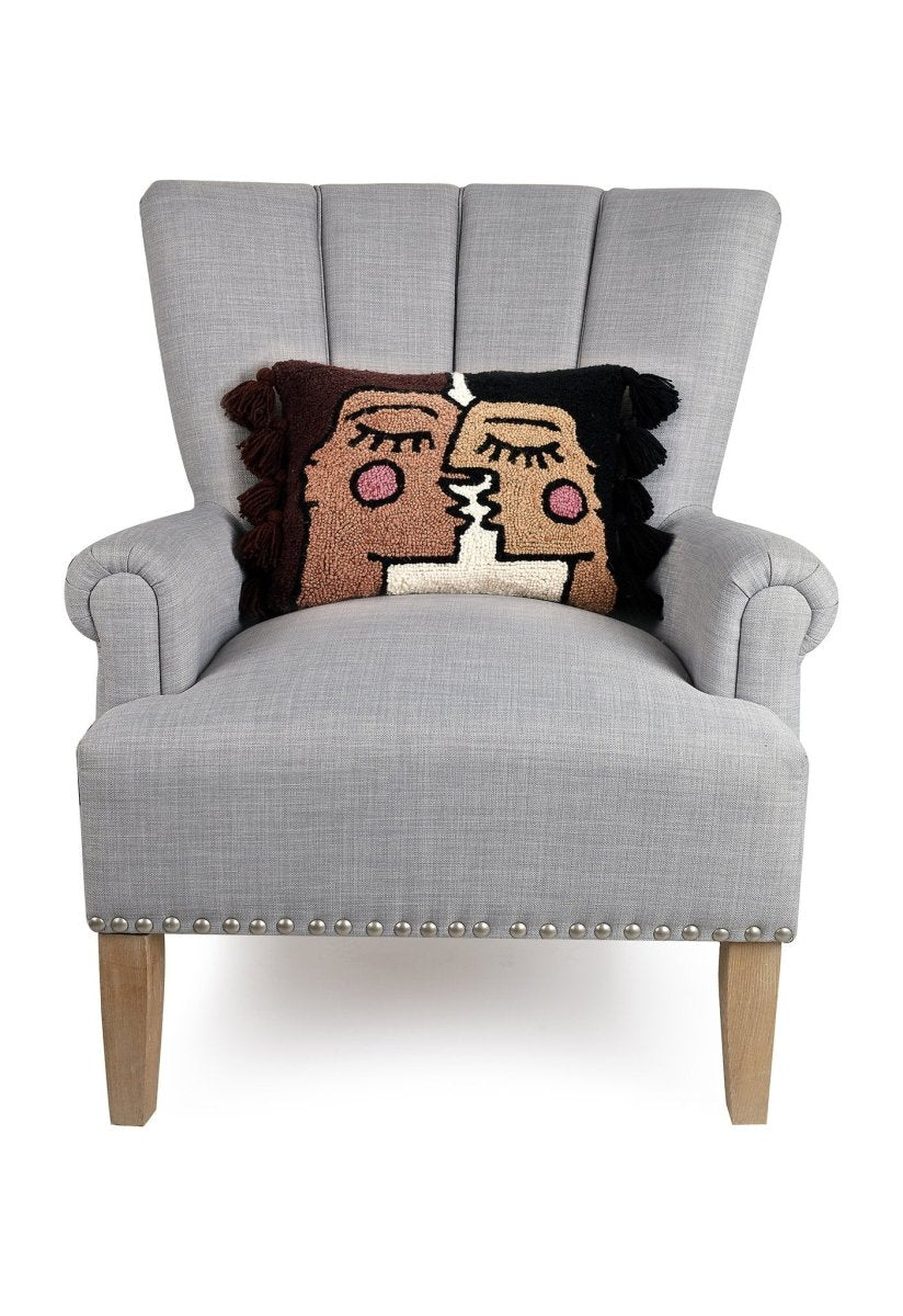 Bacio with Tassels Hooked Wool Throw Pillow on an armchair, showing the throw pillow at room scale, 12x16 inch
