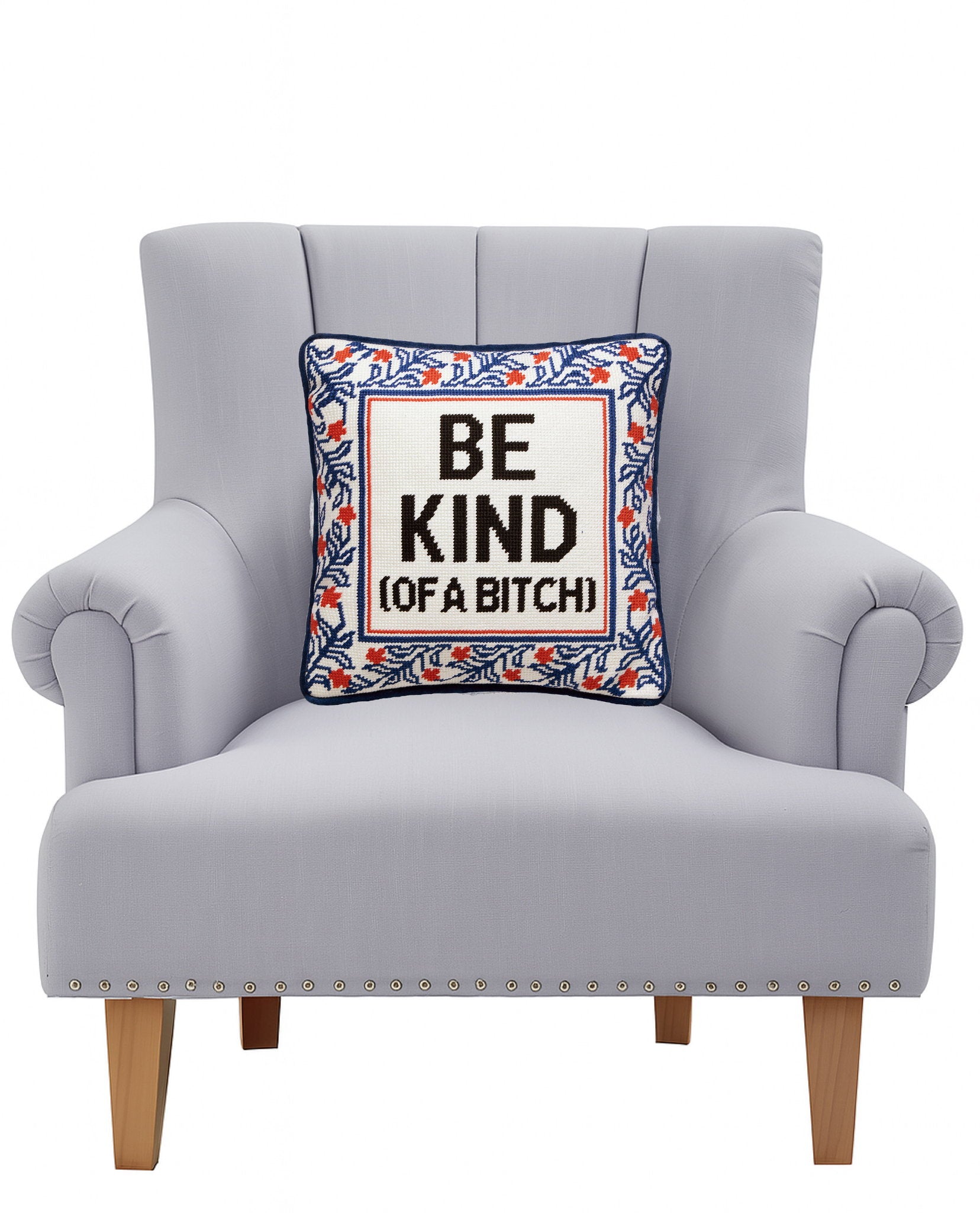 Be Kind (of a Bitch) Embroidered Needlepoint Throw Pillow on an armchair, showing the throw pillow at room scale, 12x12 inch
