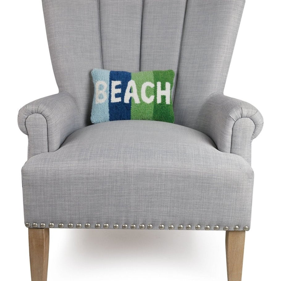 Beach Hooked Wool Throw Pillow on an armchair, showing the throw pillow at room scale, 8x12 inch
