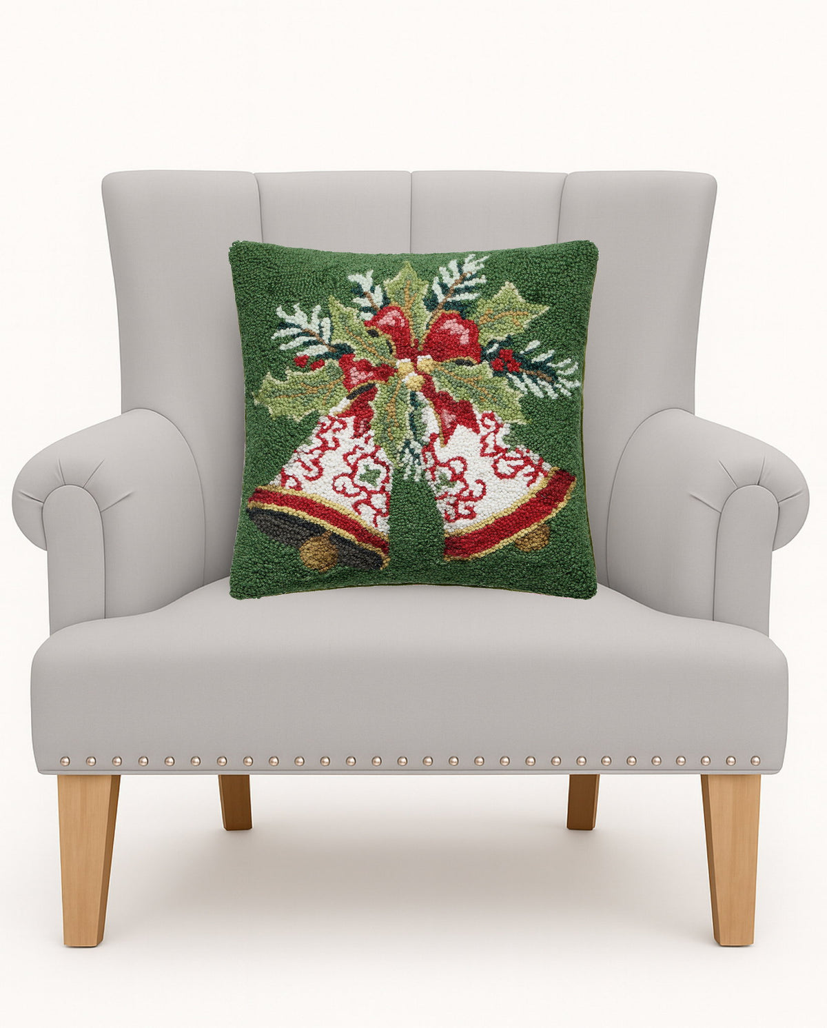Bells Hooked Wool Christmas Throw Pillow on an armchair, showing the throw pillow at room scale, 16x16 inch