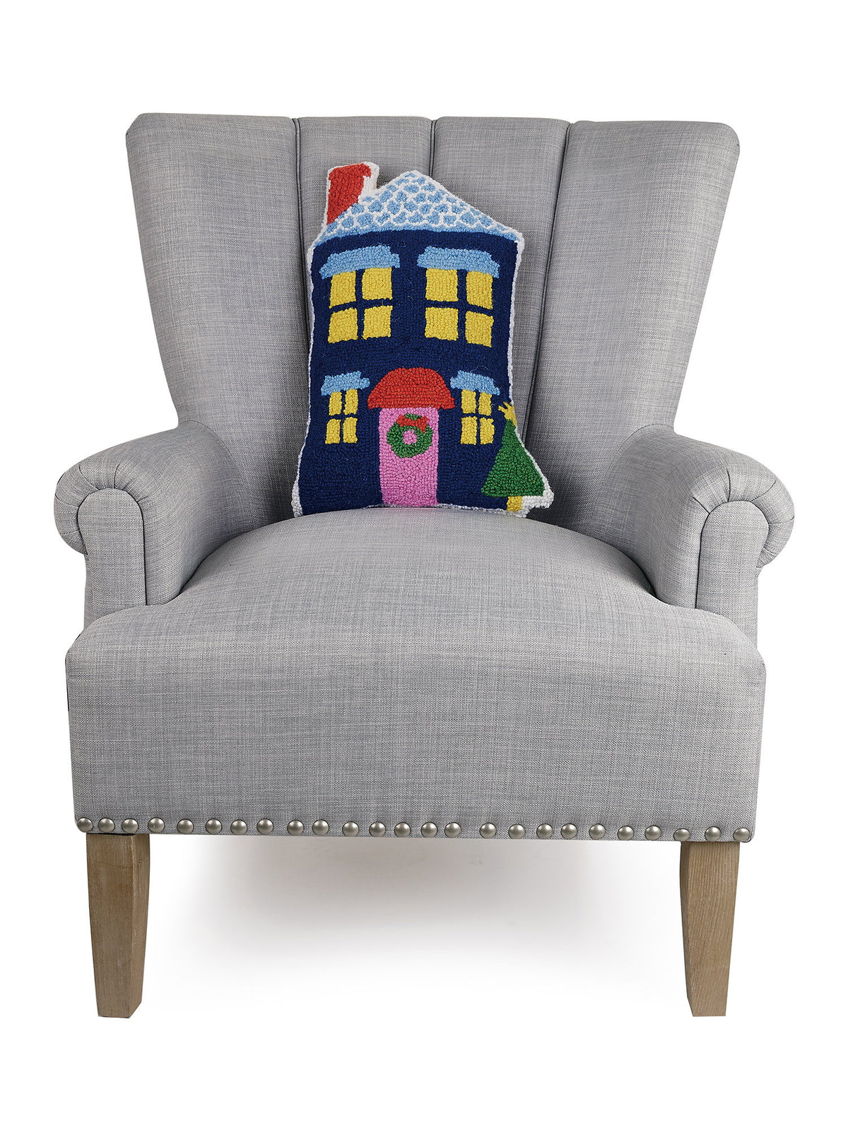 Blue House Shaped Hooked Wool Christmas Throw Pillow on an armchair, showing the throw pillow at room scale, 12x18 inch