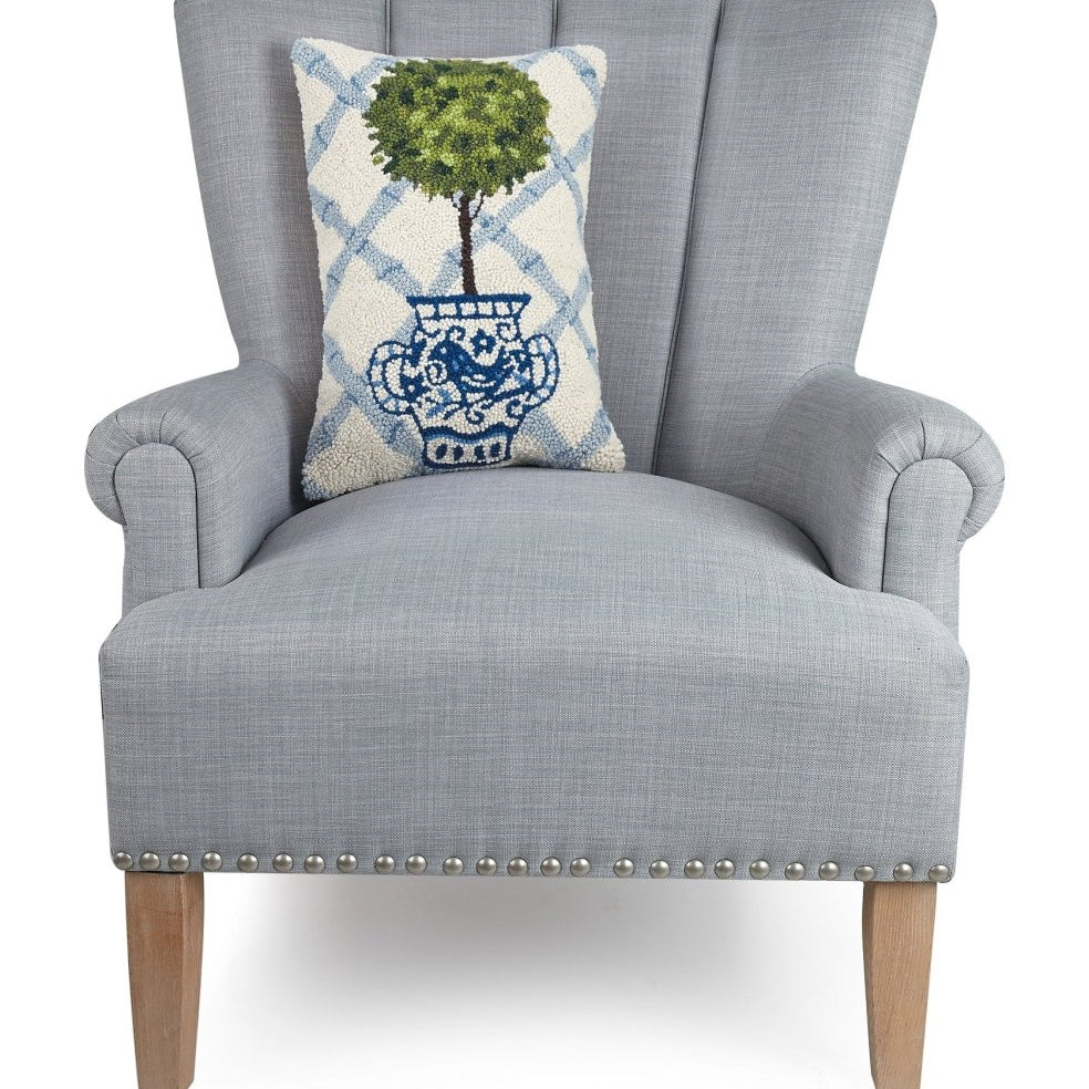 Blue Lattice Ball Topiary Hooked Wool Throw Pillow on an armchair, showing the throw pillow at room scale, 12x18 inch