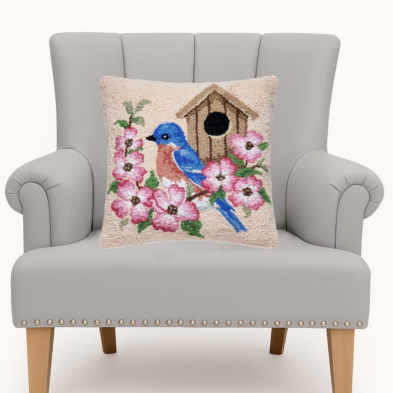 Bluebird Birdhouse Hooked Wool Throw Pillow on an armchair, showing the throw pillow at room scale, 16x16 inch