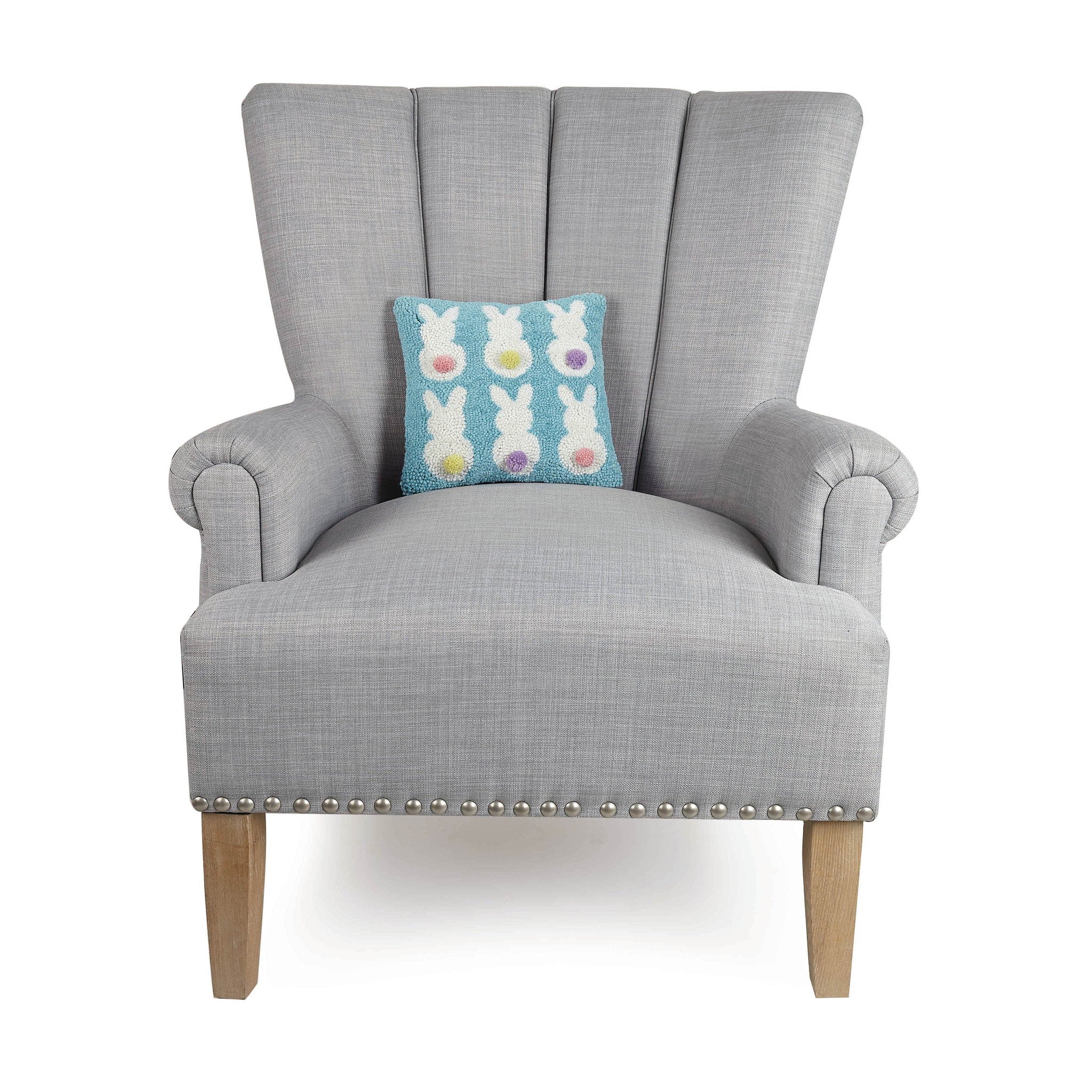 Bunny Backs Hooked Wool Easter Throw Pillow on an armchair, showing the throw pillow at room scale, 10x10 inch
