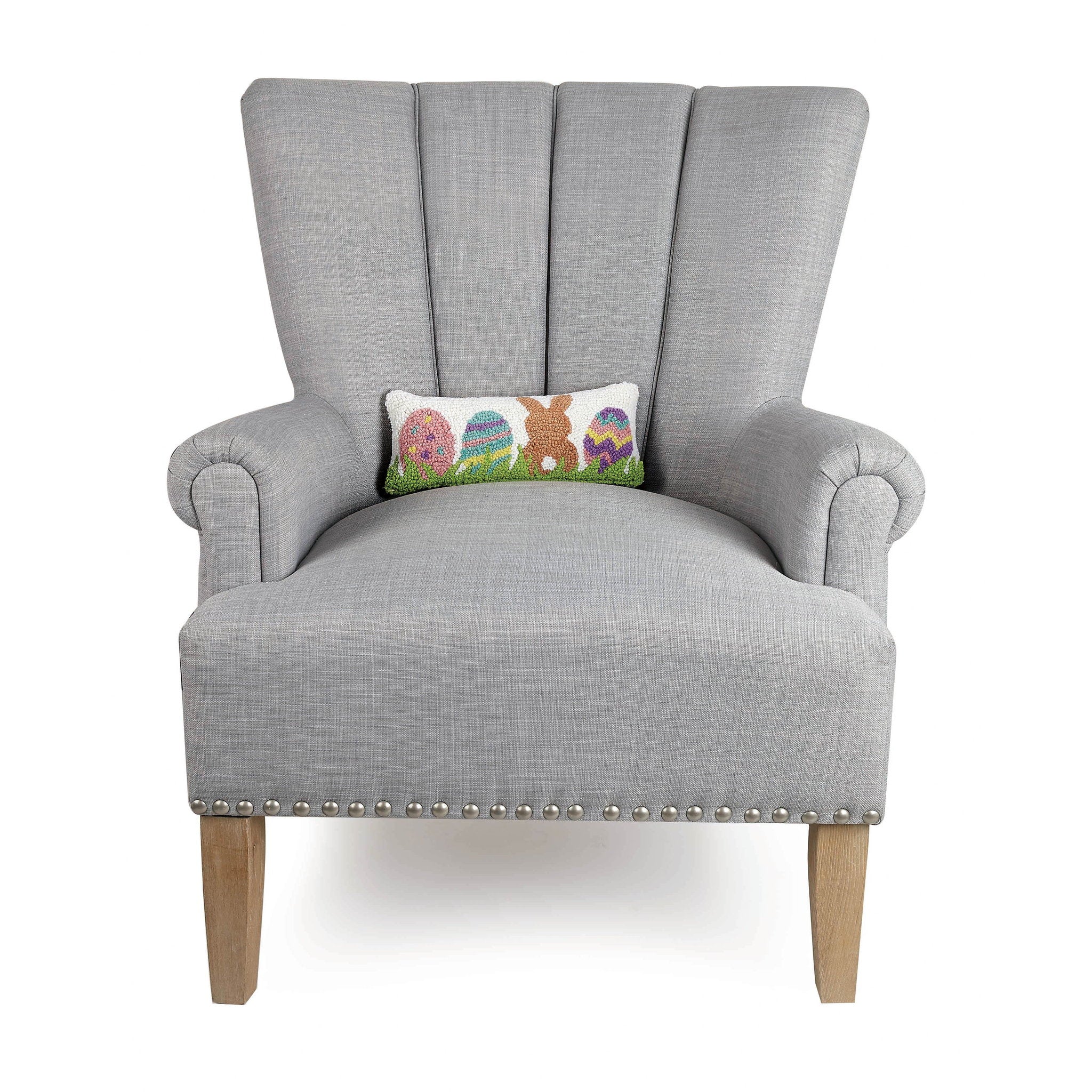Bunny with Eggs Hooked Wool Easter Throw Pillow on an armchair, showing the throw pillow at room scale, 12x5 inch