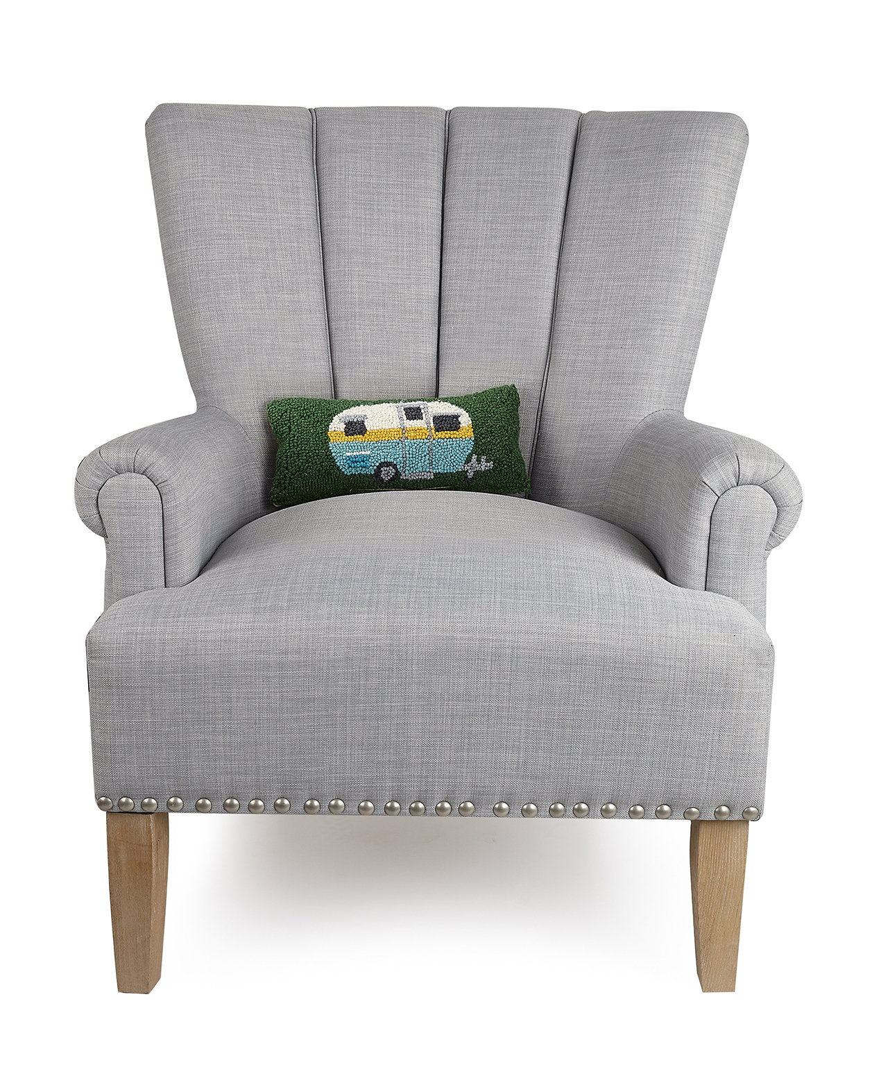 Camper Hooked Wool Throw Pillow on an armchair, showing the throw pillow at room scale, 12x5 inch