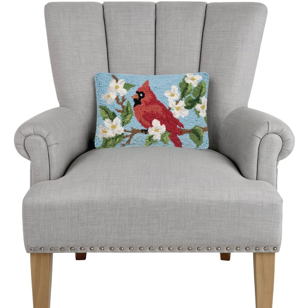 Cardinal Hooked Wool Throw Pillow on an armchair, showing the throw pillow at room scale, 8x12 inch