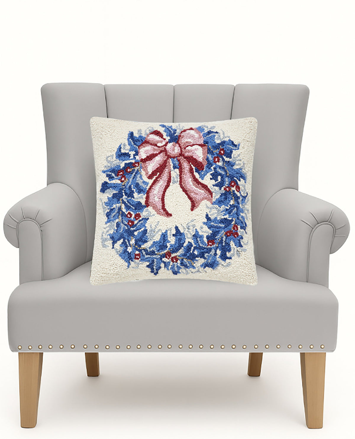 Chinoiserie Wreath Hooked Wool Christmas Throw Pillow on an armchair, showing the throw pillow at room scale, 18x18 inch