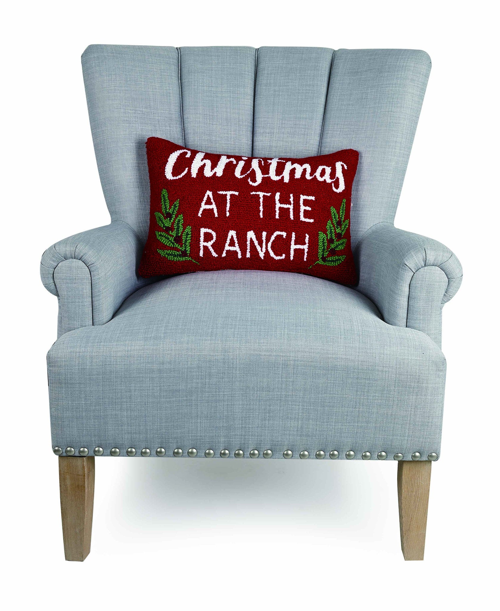 Christmas at the Ranch Hooked Wool Throw Pillow on an armchair, showing the throw pillow at room scale, 12x18 inch