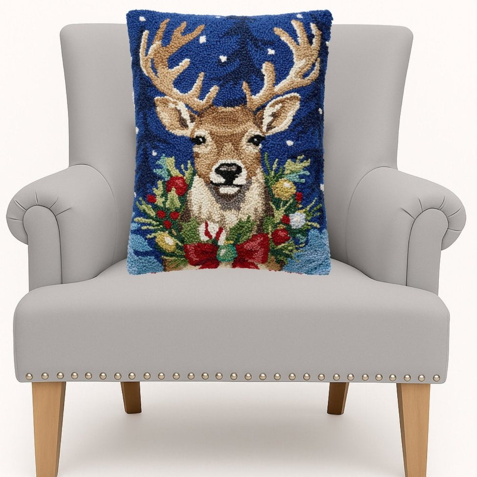 Christmas Deer Hooked Wool Throw Pillow on an armchair, showing the throw pillow at room scale, 14x18 inch