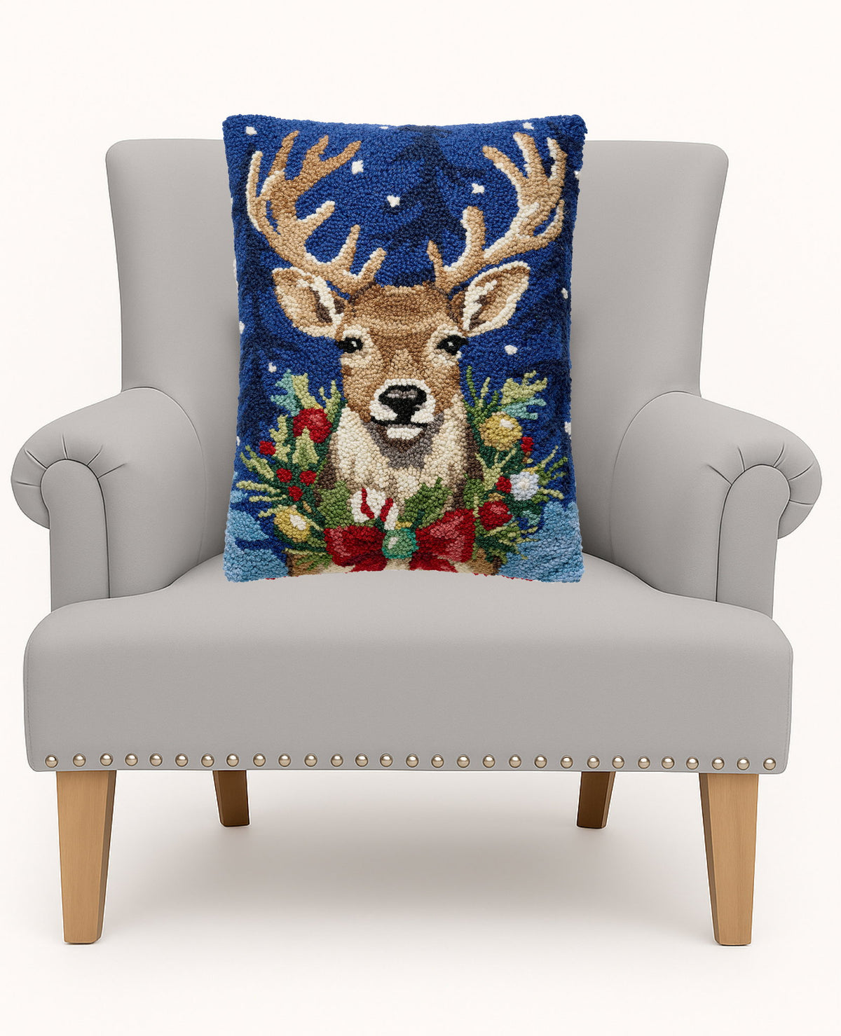 Christmas Deer Hooked Wool Throw Pillow on an armchair, showing the throw pillow at room scale, 14x18 inch
