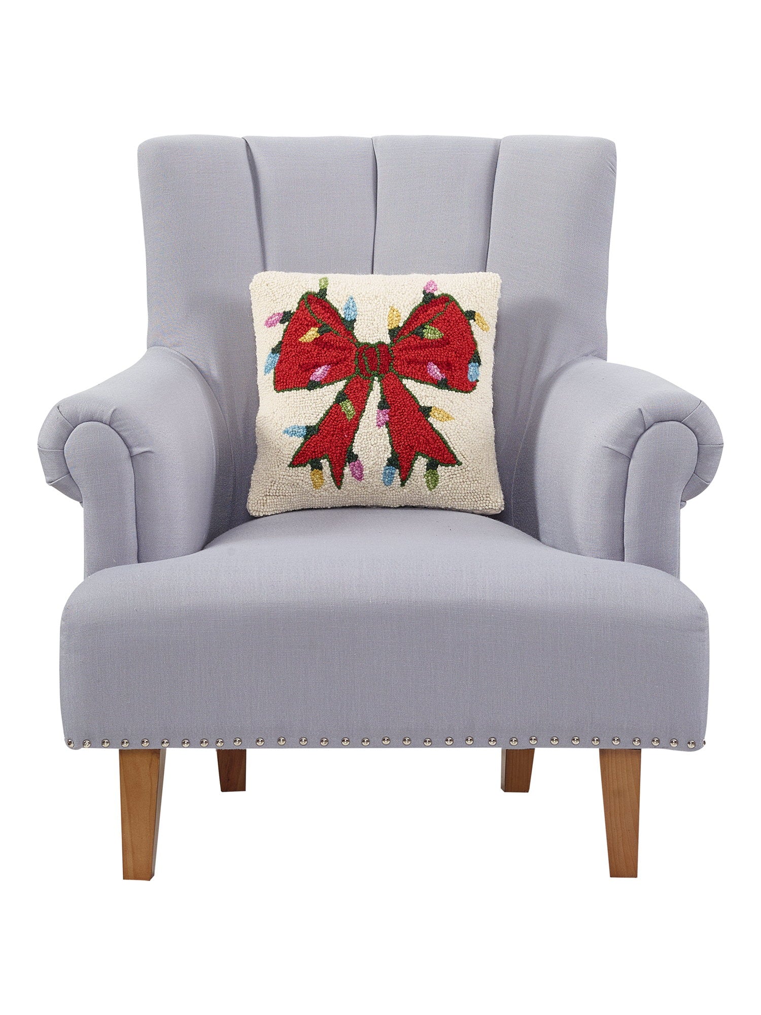 Christmas Lights Bow Hooked Wool Throw Pillow on an armchair, showing the throw pillow at room scale, 14x14 inch