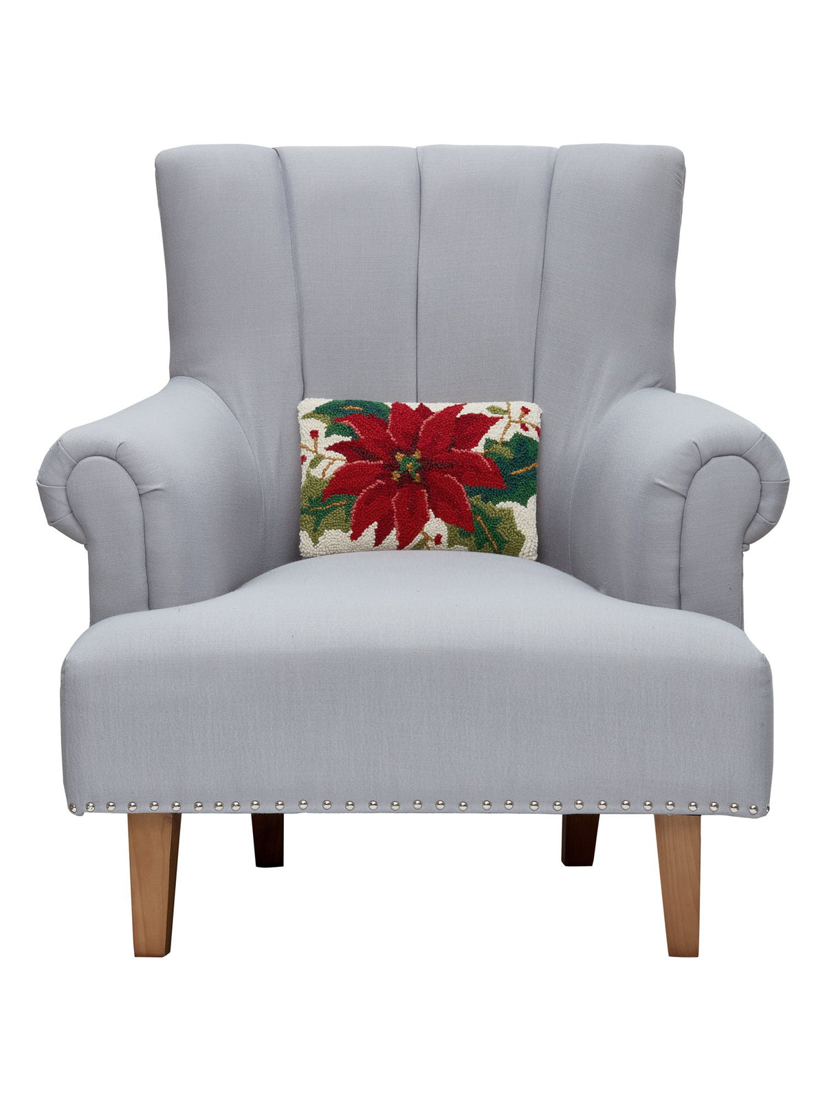 Christmas Poinsettia Hooked Wool Throw Pillow on an armchair, showing the throw pillow at room scale, 8x12 inch