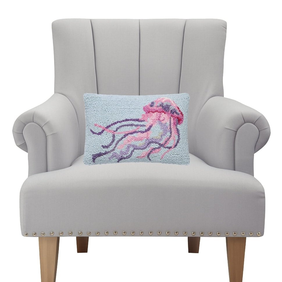 Coastal Jellyfish Hooked Wool Throw Pillow on an armchair, showing the throw pillow at room scale, 8x12 inch