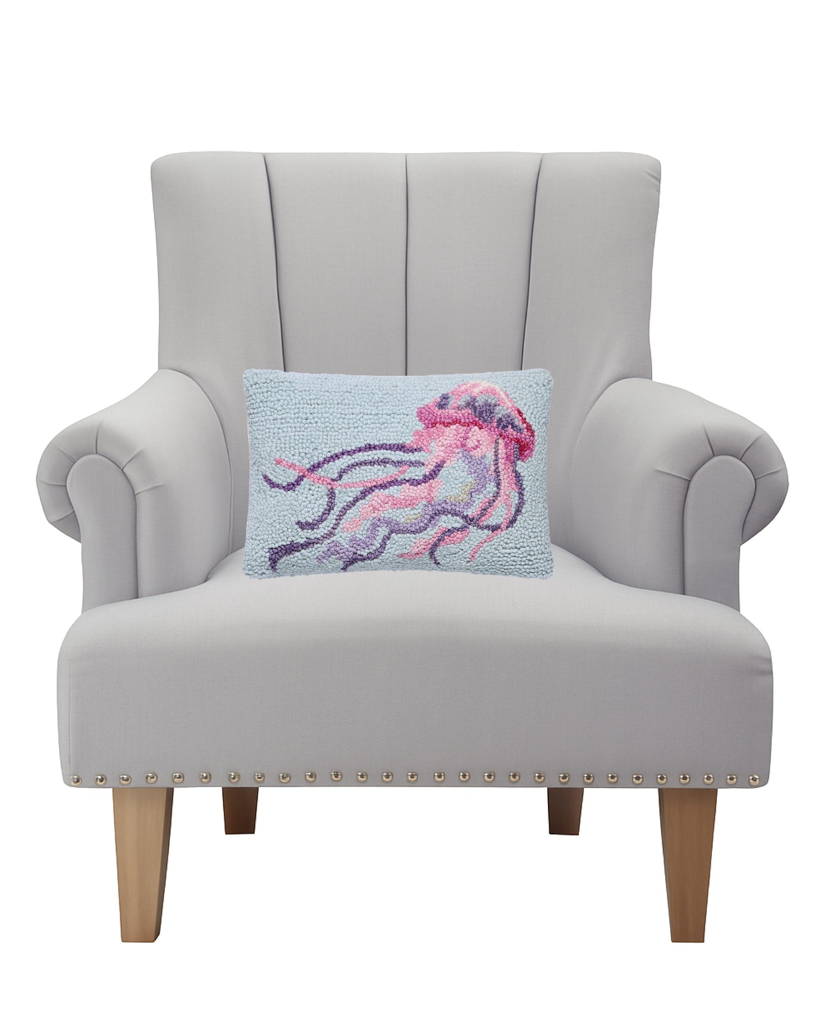 Coastal Jellyfish Hooked Wool Throw Pillow on an armchair, showing the throw pillow at room scale, 8x12 inch