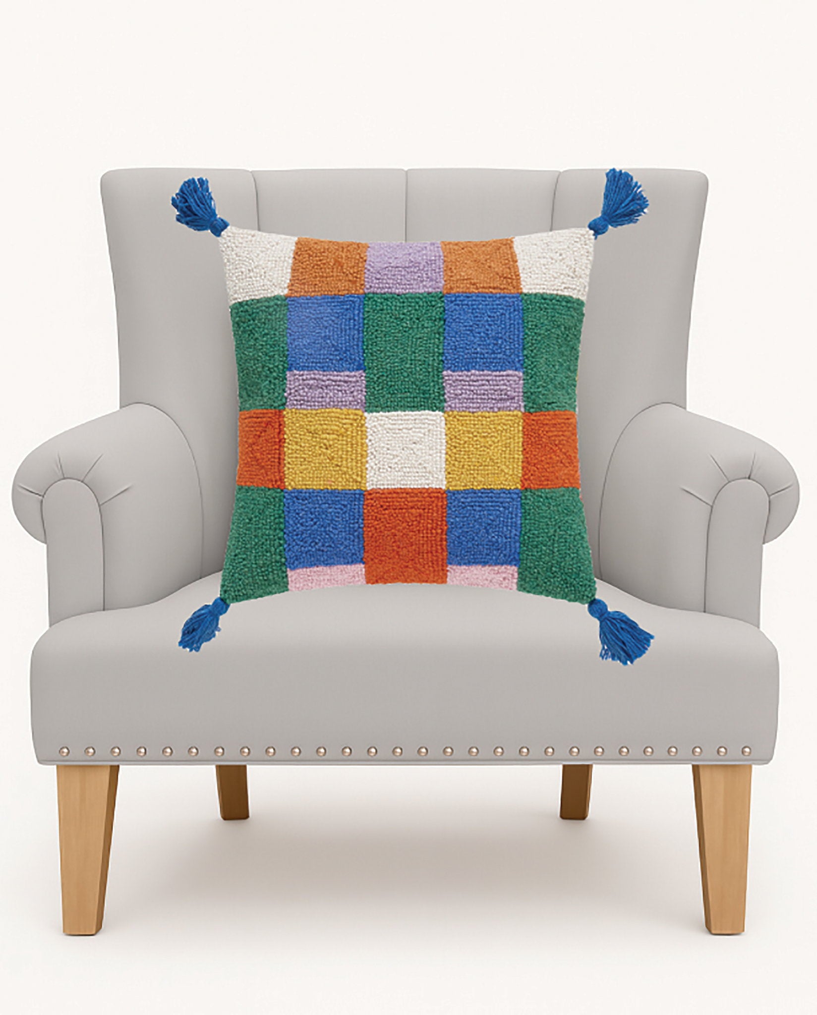 Colorful Check with Tassels Hooked Wool Throw Pillow on an armchair, showing the throw pillow at room scale, 16x16 inch