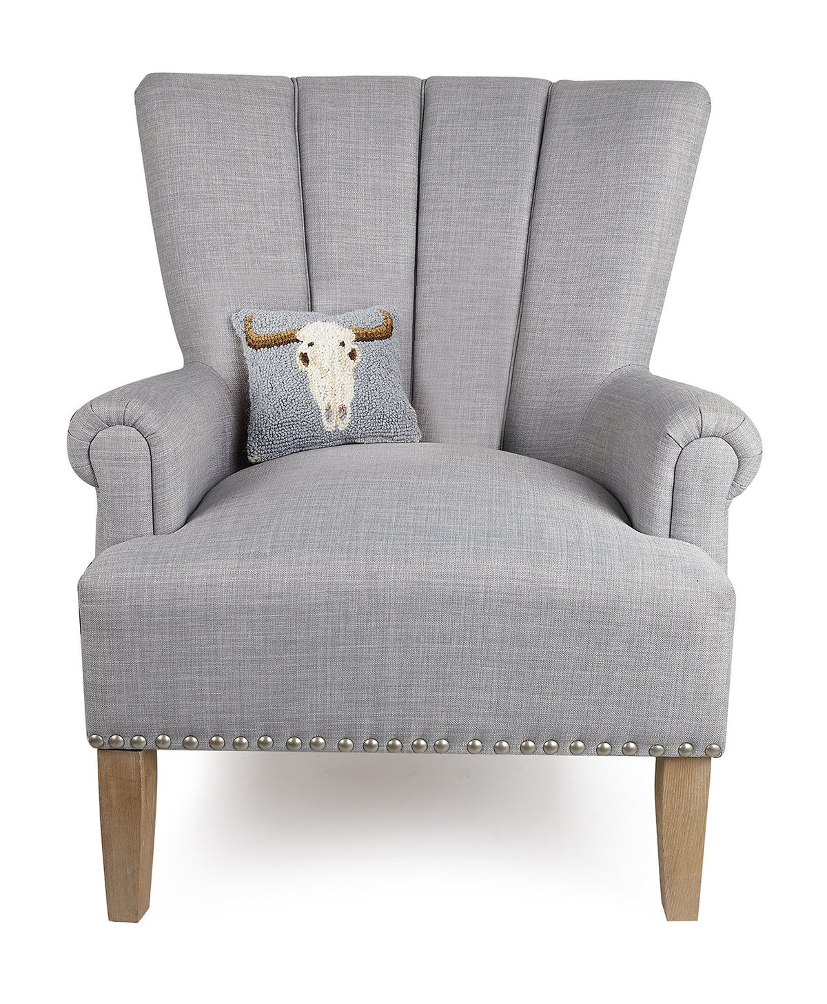 Cow Skull Hooked Wool Halloween Throw Pillow on an armchair, showing the throw pillow at room scale, 8x18 inch