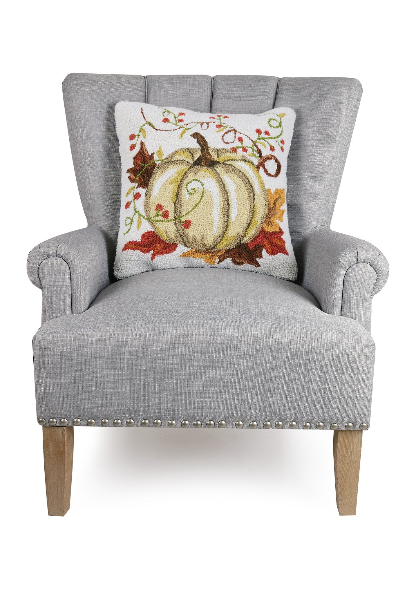 Cream Harvest Pumpkin Hooked Wool Fall Harvest Throw Pillow on an armchair, showing the throw pillow at room scale, 18x18 inch