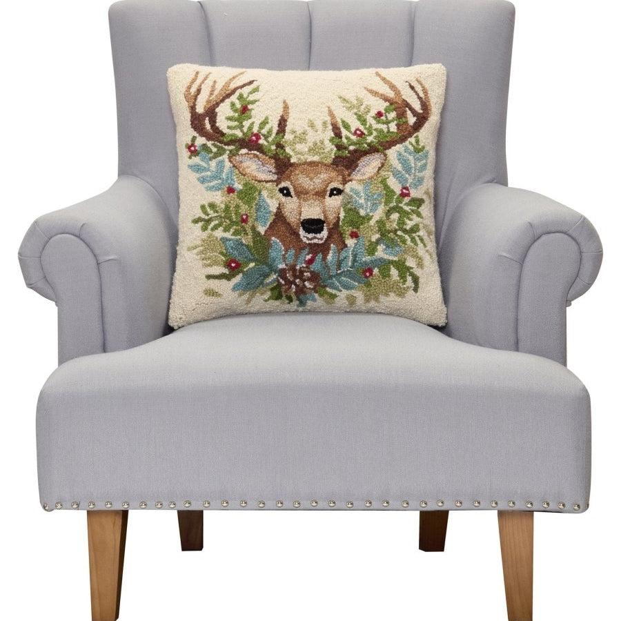 Deer Hooked Wool Christmas Throw Pillow on an armchair, showing the throw pillow at room scale, 18x18 inch