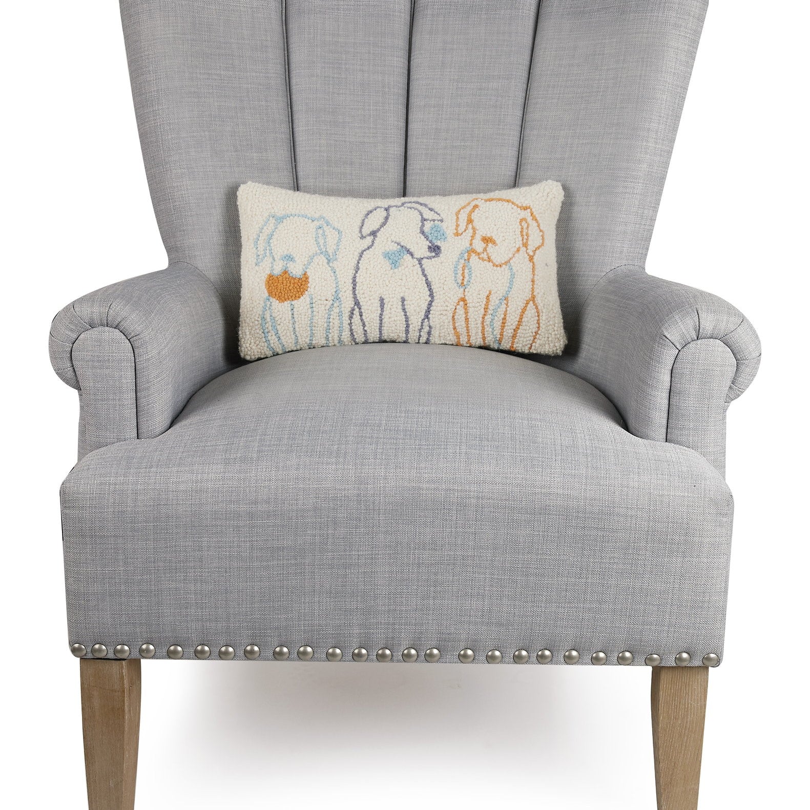 Dog Silhouettes Hooked Wool Throw Pillow on an armchair, showing the throw pillow at room scale, 9x16 inch