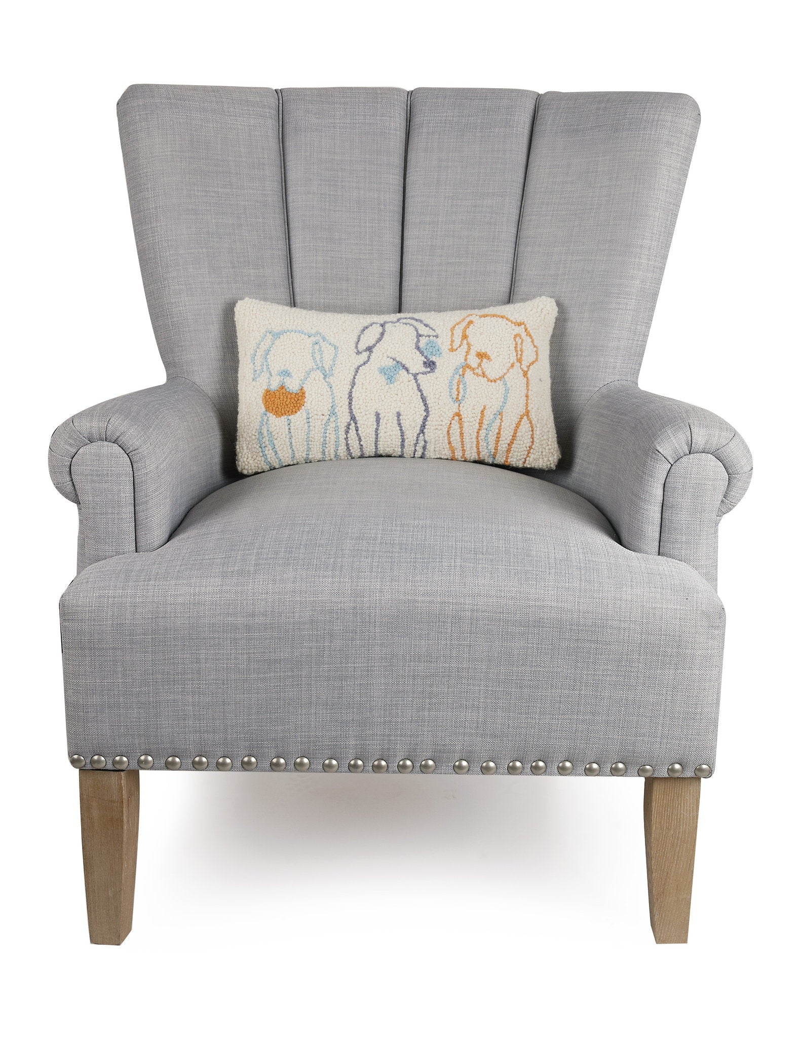 Dog Silhouettes Hooked Wool Throw Pillow on an armchair, showing the throw pillow at room scale, 9x16 inch