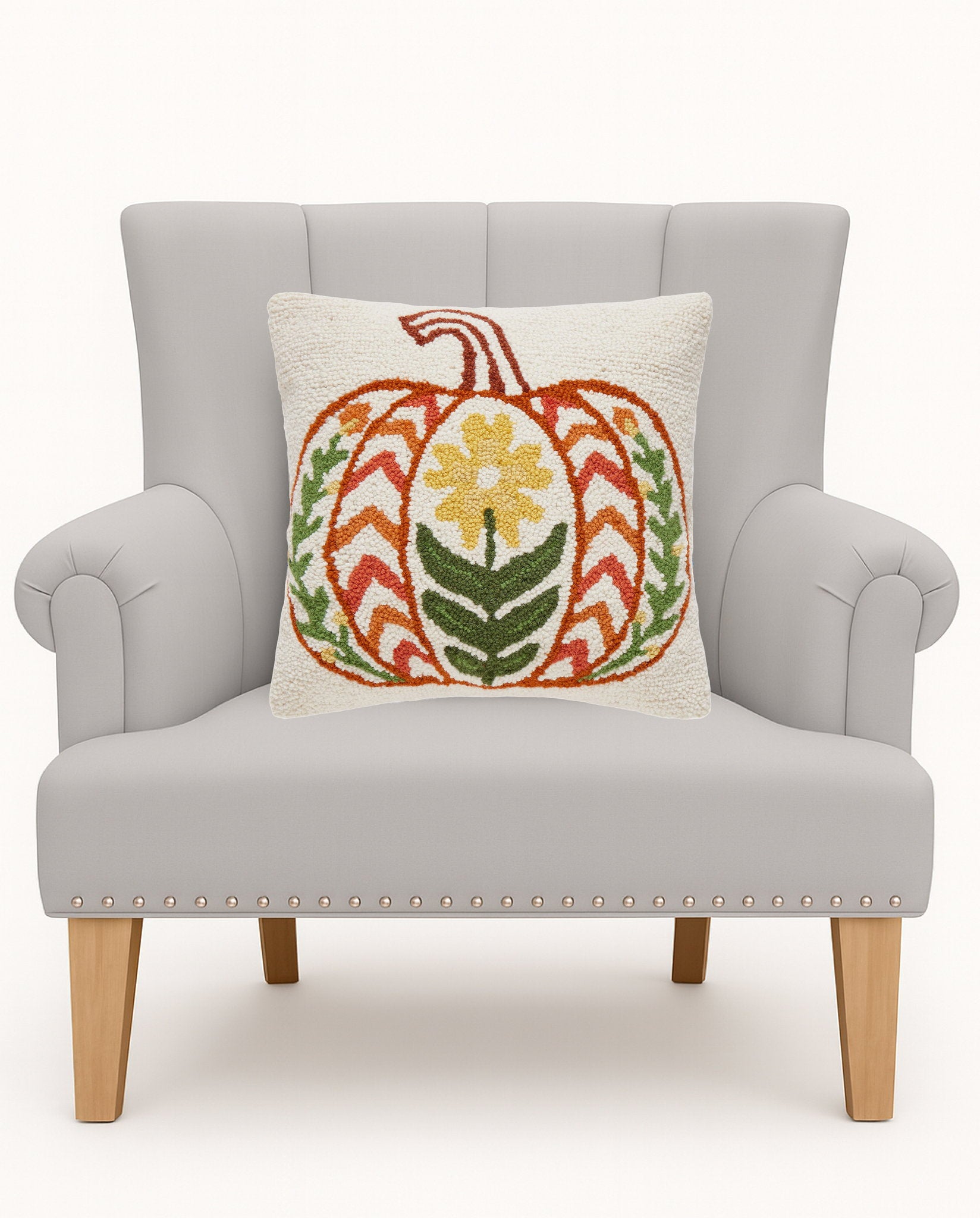 Fall Folk Pumpkin Hooked Wool Throw Pillow on an armchair, showing the throw pillow at room scale, 16x16 inch