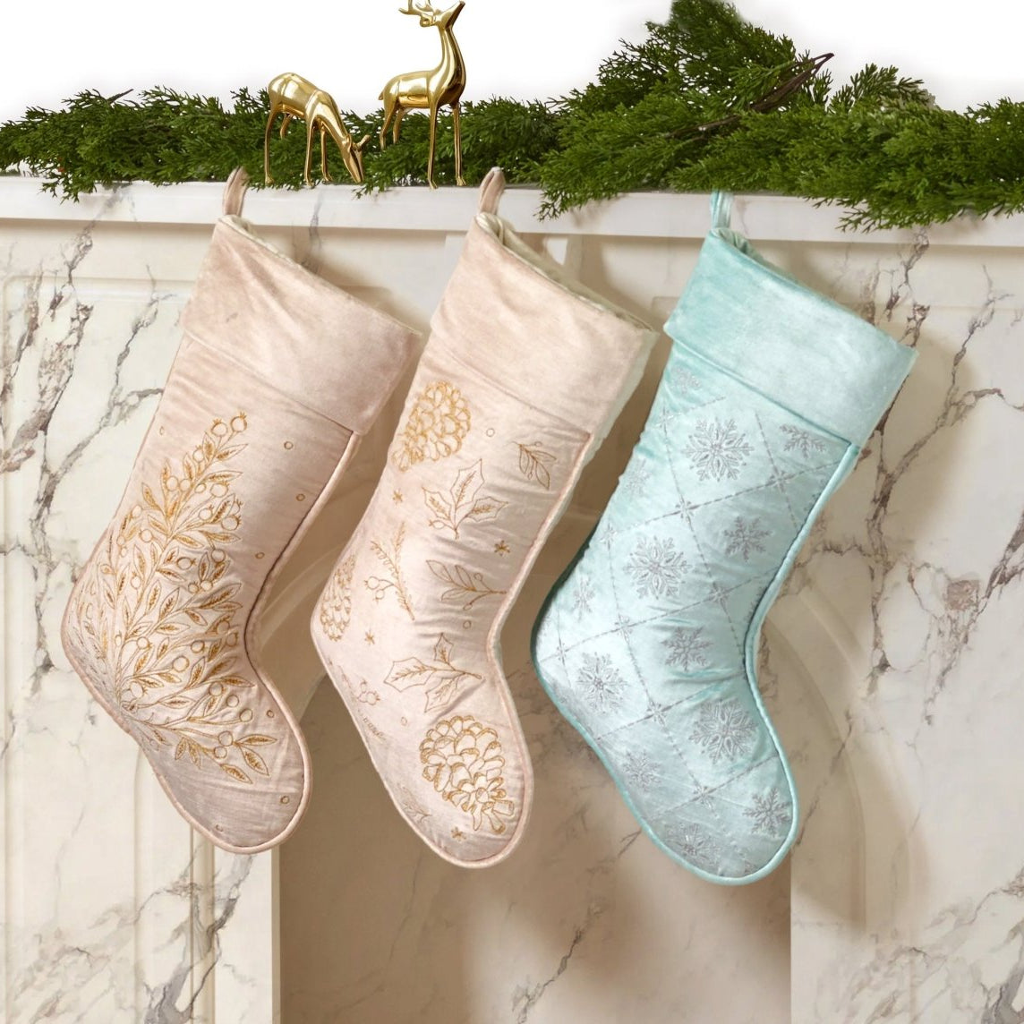 Frosty Blue Snowflake Embroidered Christmas Stocking shown alongside other designs in the same collection, 12x20 inch