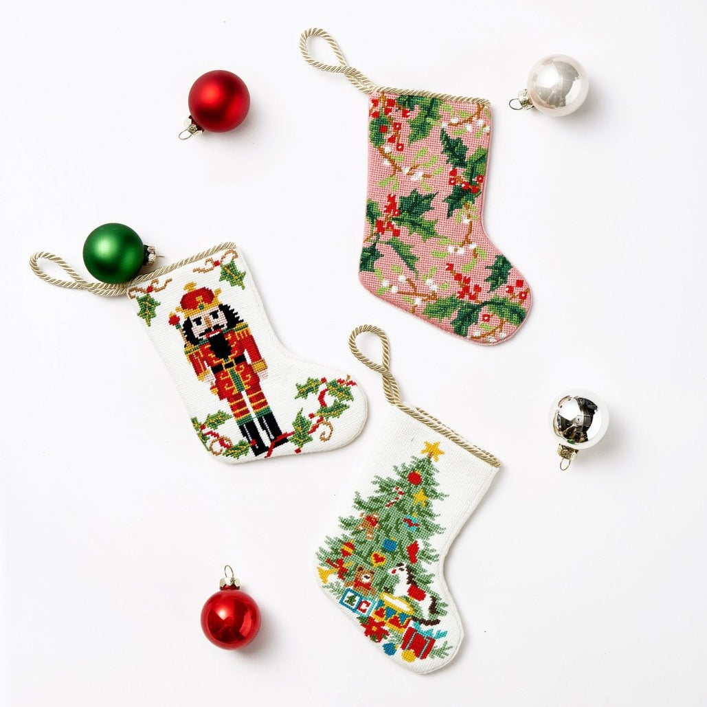 Full Figure Nutcracker Mini Embroidered Needlepoint Christmas Stocking, 6x4 inch, three stockings laid flat with red and green baubles