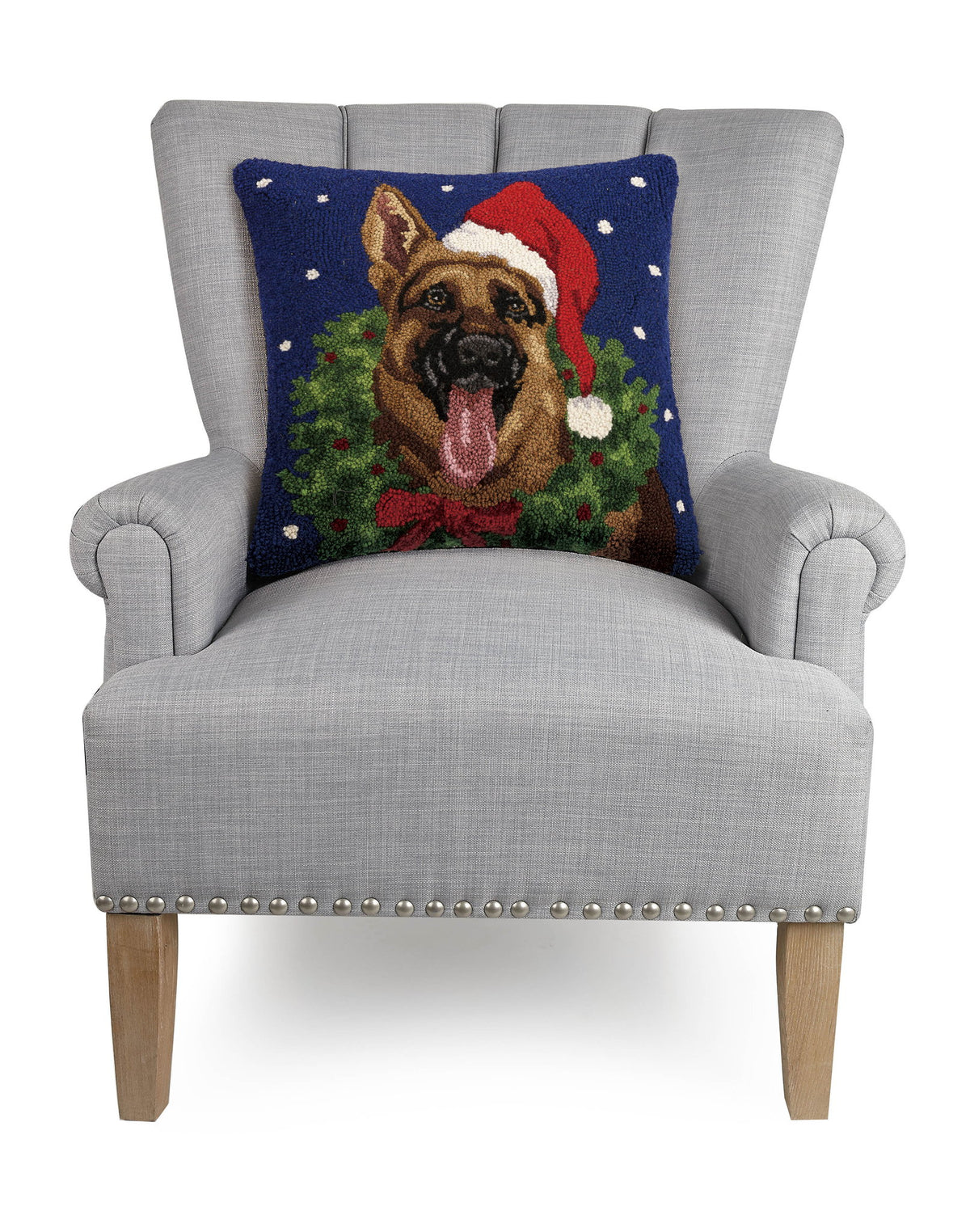 German Shepherd with Wreath Hooked Wool Christmas Throw Pillow on an armchair, showing the throw pillow at room scale, 18x18 inch