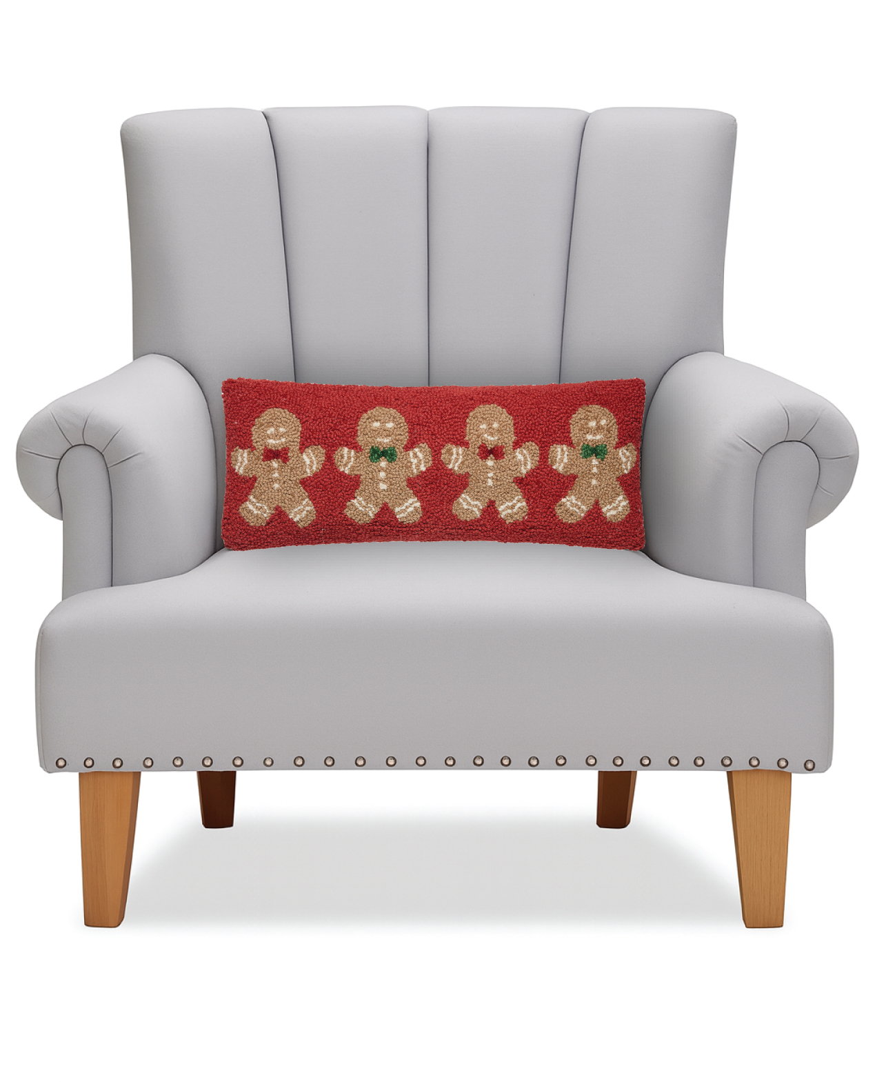 Gingerbread Cookies Hooked Wool Christmas Throw Pillow on an armchair, showing the throw pillow at room scale, 8x20 inch