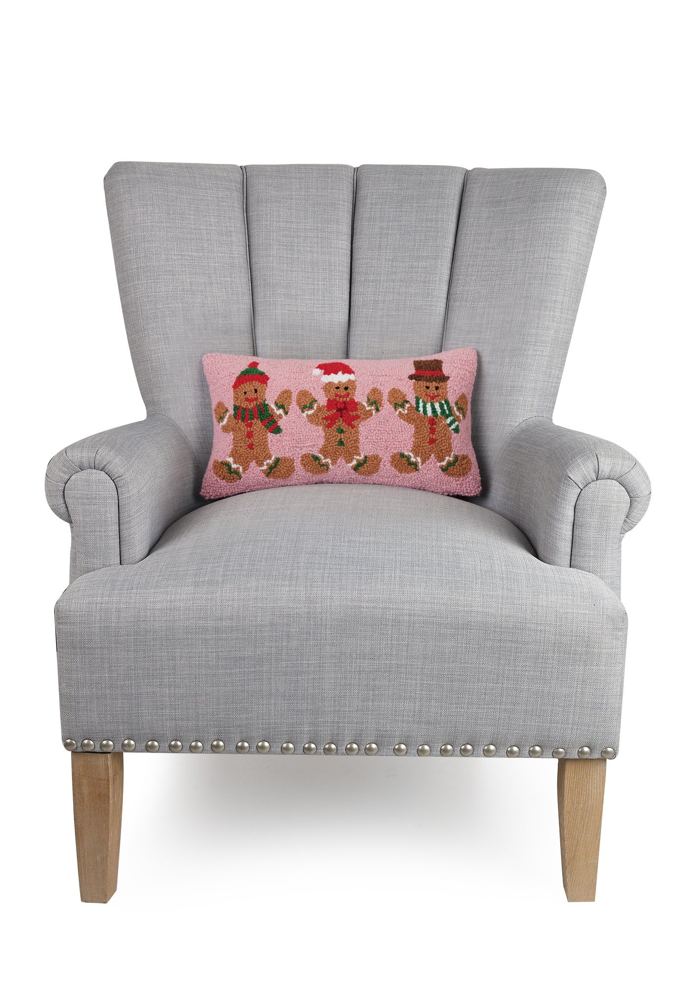 Gingerbreads Group Three Hooked Wool Christmas Throw Pillow on an armchair, showing the throw pillow at room scale, 9x16 inch