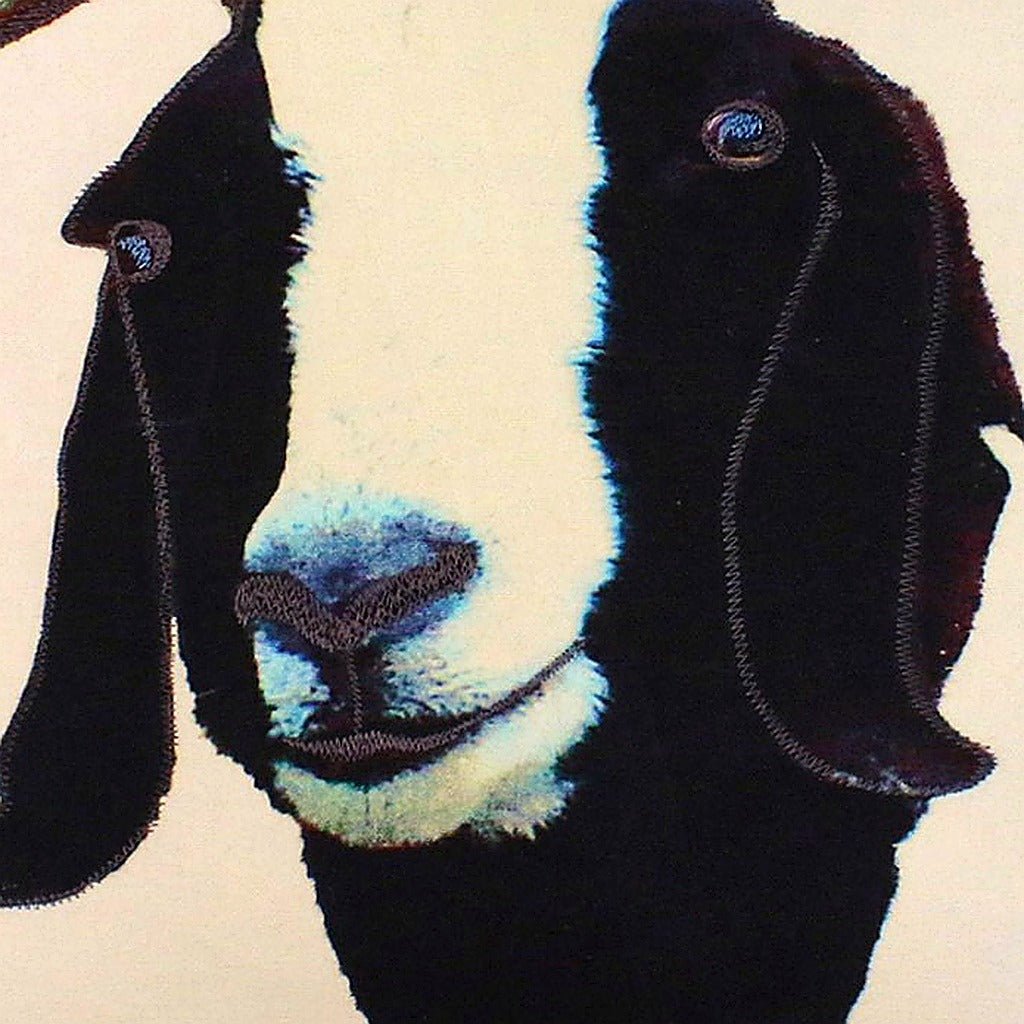 Goat pillow fabric closeup showing hand-embroidered needlepoint wool texture and color detail