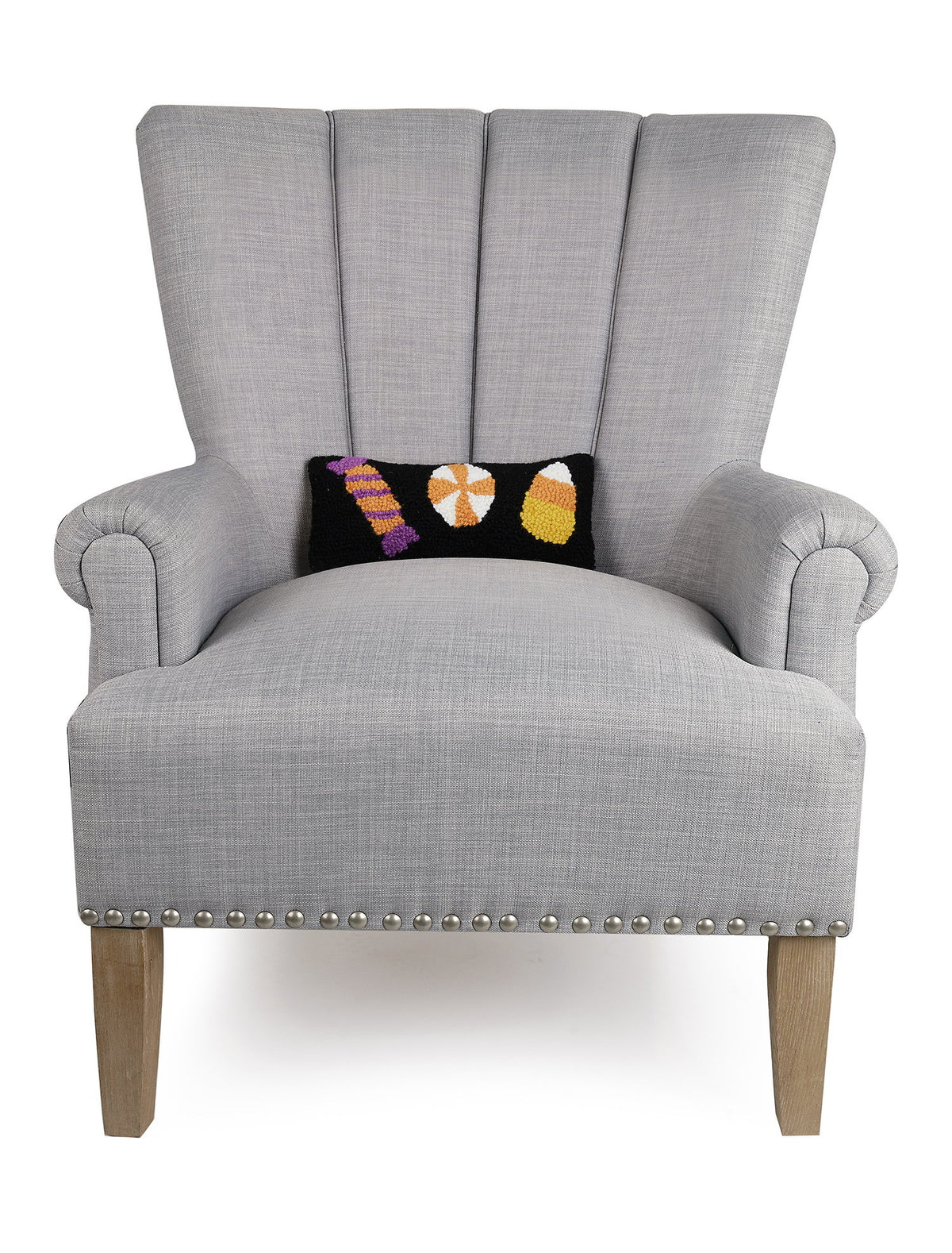 Halloween Candies Trio Hooked Wool Throw Pillow on an armchair, showing the throw pillow at room scale, 12x5 inch