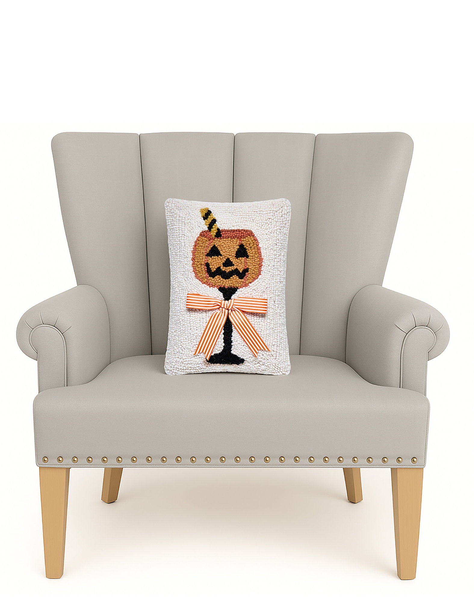 Halloween Drink Hooked Wool Throw Pillow on an armchair, showing the throw pillow at room scale, 8x12 inch