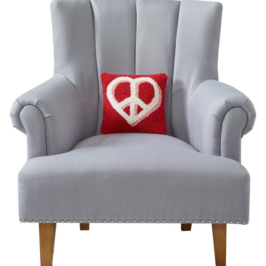Heart Anchor Hooked Wool Throw Pillow on an armchair, showing the throw pillow at room scale, 10x10 inch