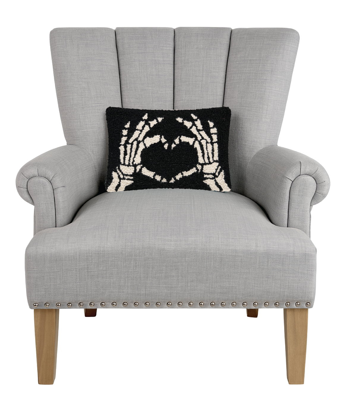 Heart Skeleton Hand Hooked Wool Halloween Throw Pillow on an armchair, showing the throw pillow at room scale, 8x12 inch