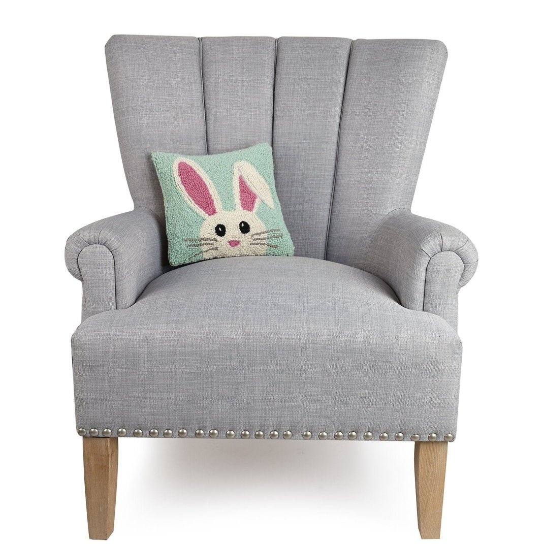 Hello Easter Bunny Hooked Wool Throw Pillow on an armchair, showing the throw pillow at room scale, 10x10 inch