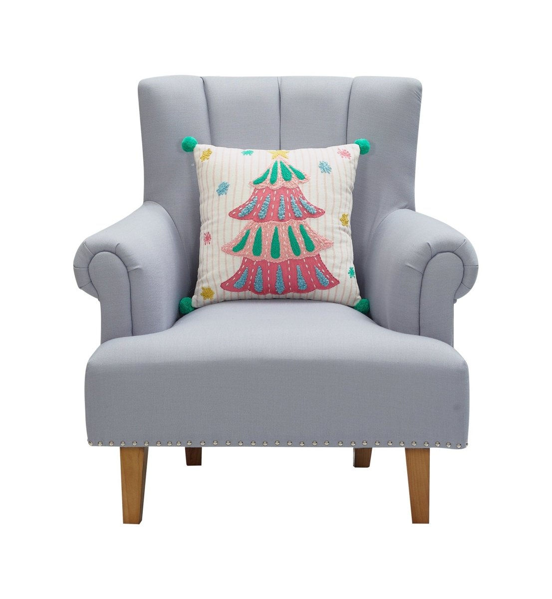 Holiday Bright's Tree with Pom Poms Embroidered Christmas Throw Pillow, 16x16 inch, tree design on a gray armchair