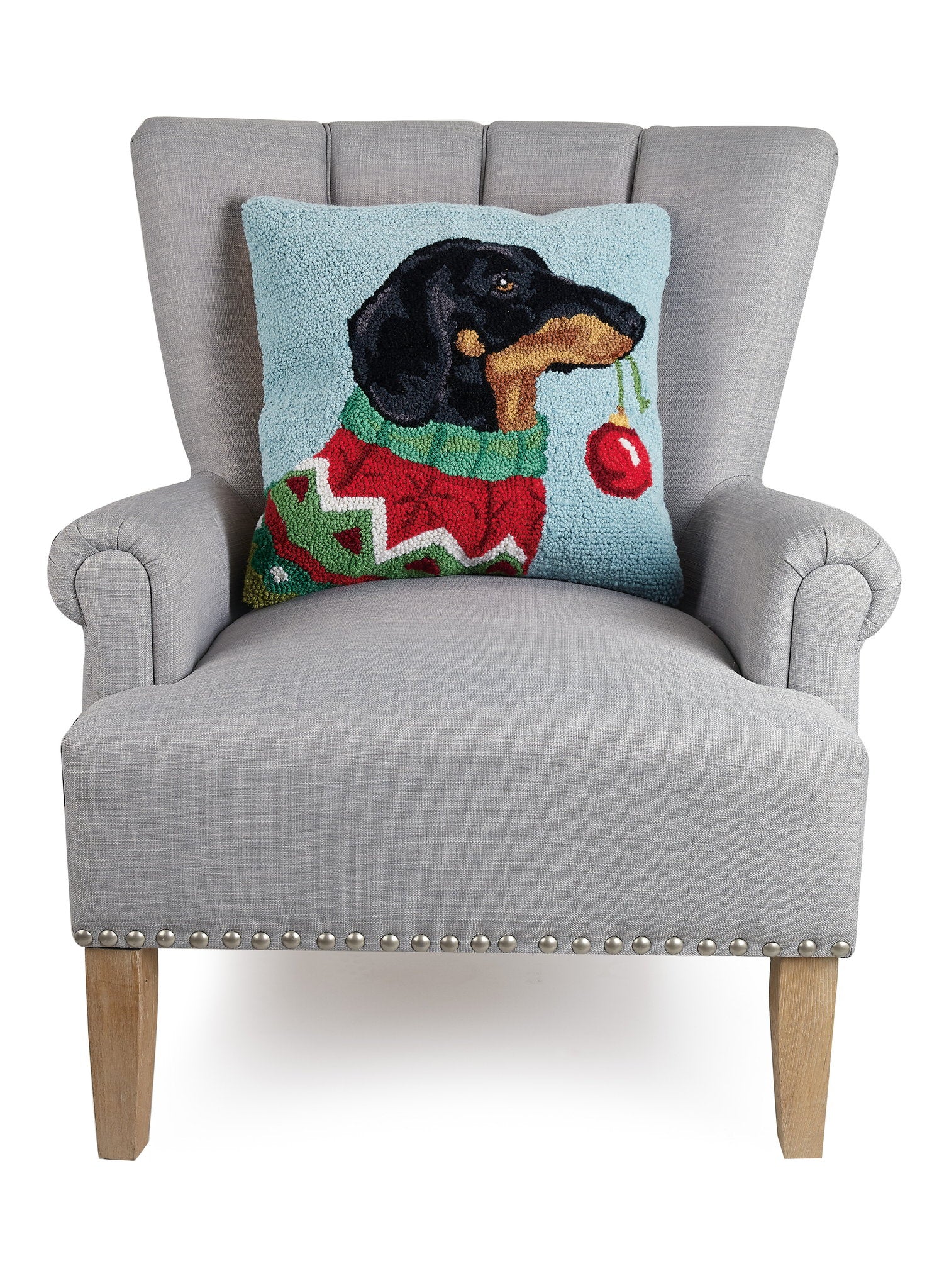 Holiday Dachshund Hooked Wool Christmas Throw Pillow on an armchair, showing the throw pillow at room scale, 18x18 inch