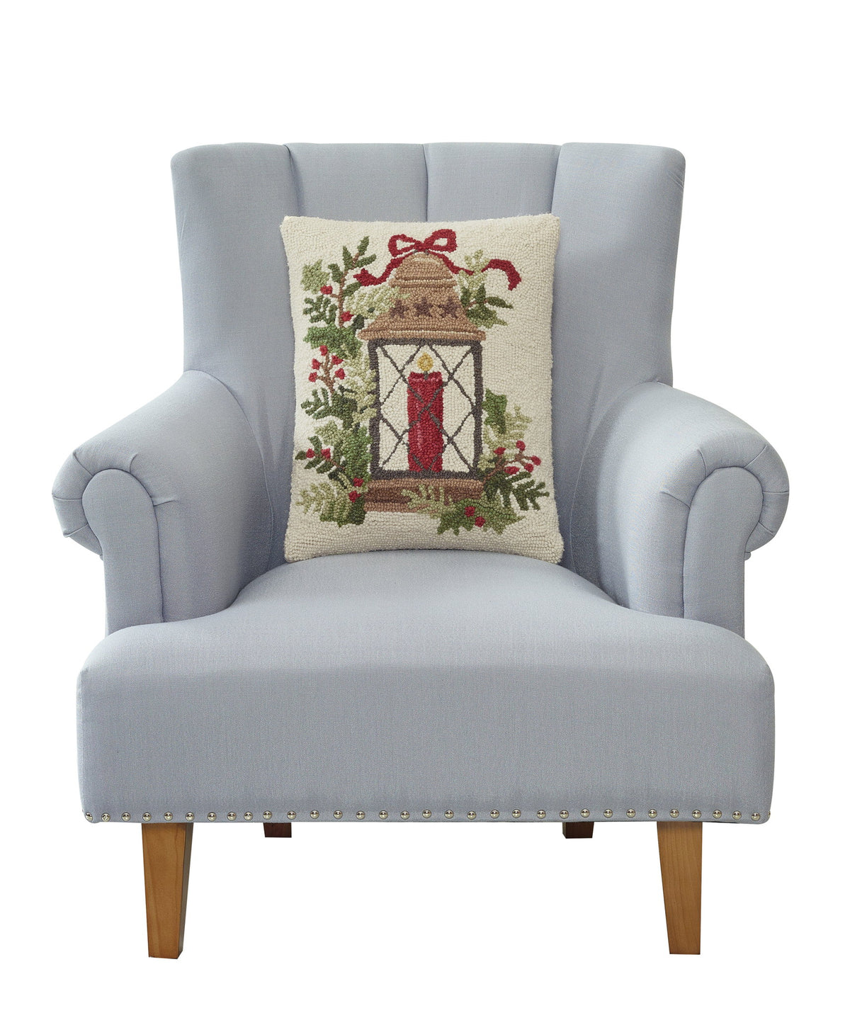 Holiday Lantern Hooked Wool Christmas Throw Pillow on an armchair, showing the throw pillow at room scale, 14x18 inch