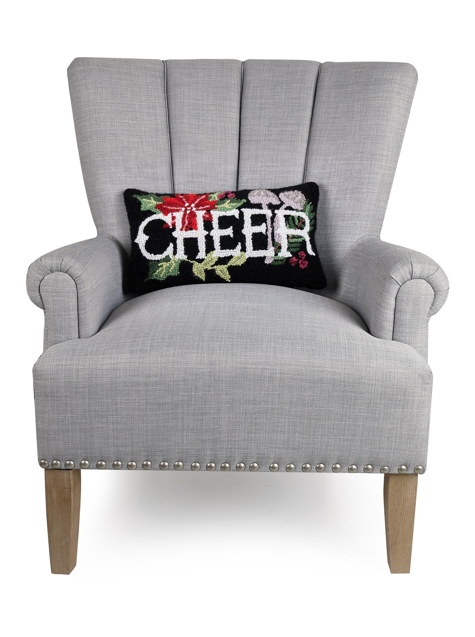 Holiday Mushrooms Cheer Hooked Wool Christmas Throw Pillow on an armchair, showing the throw pillow at room scale, 9x16 inch