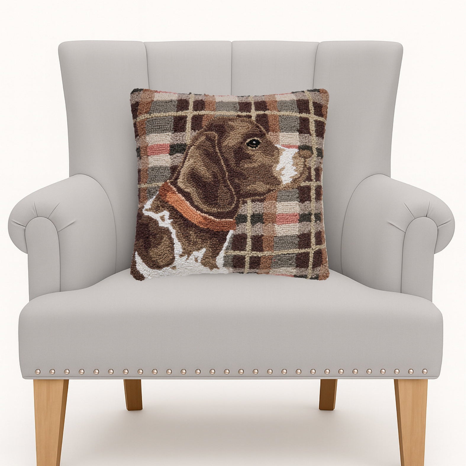 Hunting Dog Hooked Wool Throw Pillow on an armchair, showing the throw pillow at room scale, 16x16 inch