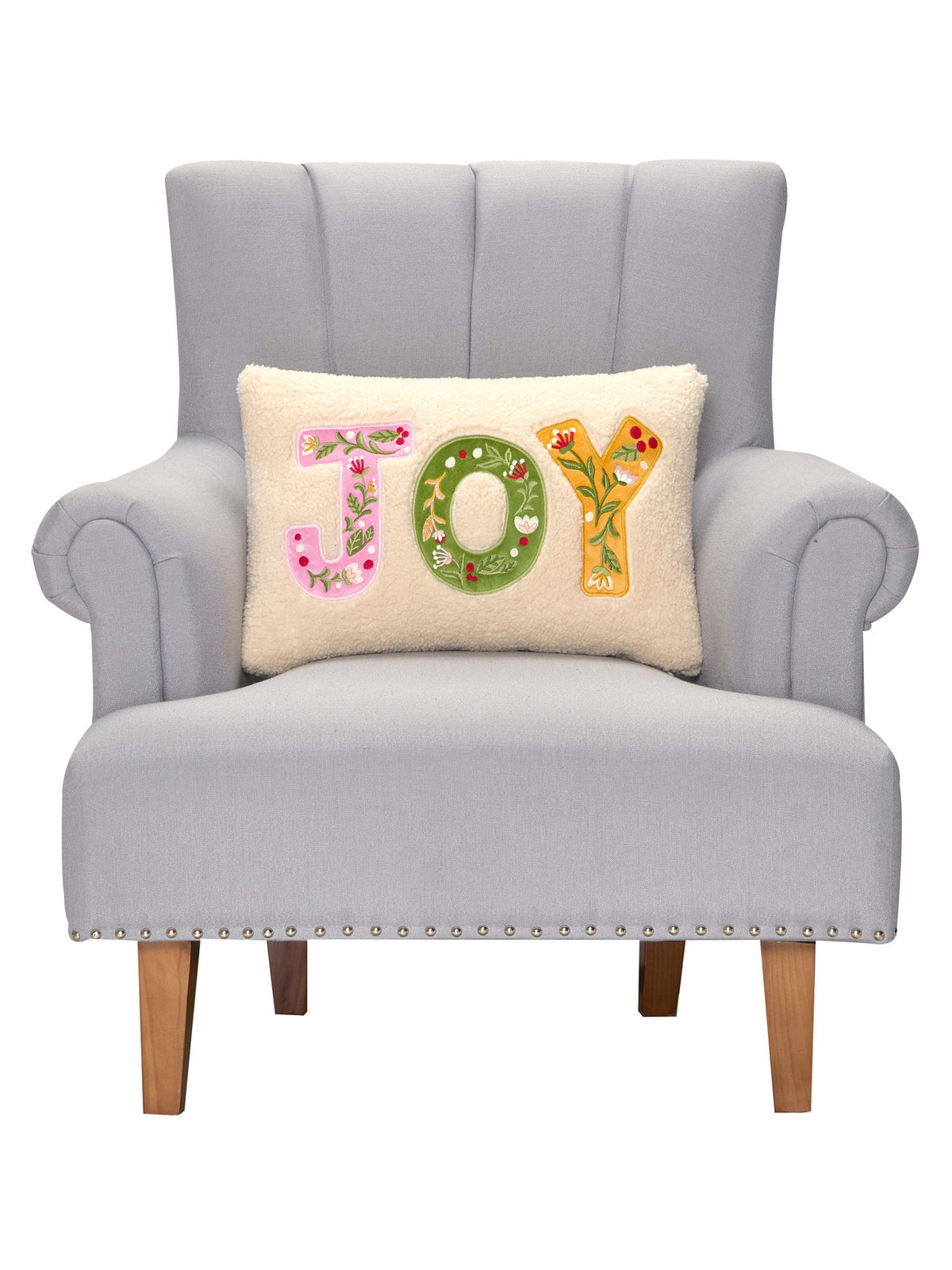 Joy Applique Embroidered Christmas Throw Pillow on an armchair, showing the throw pillow at room scale, 12x18 inch