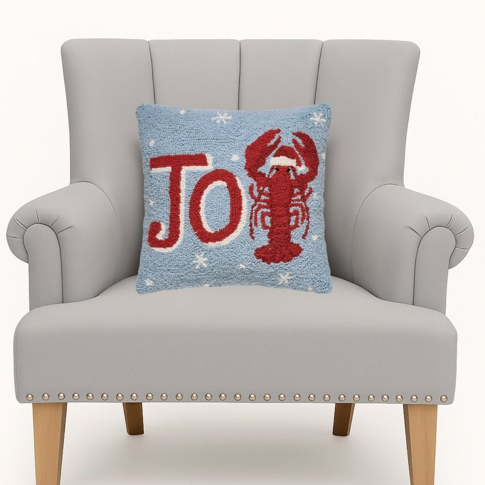 Joy Lobster Hooked Wool Christmas Throw Pillow on an armchair, showing the throw pillow at room scale, 14x14 inch