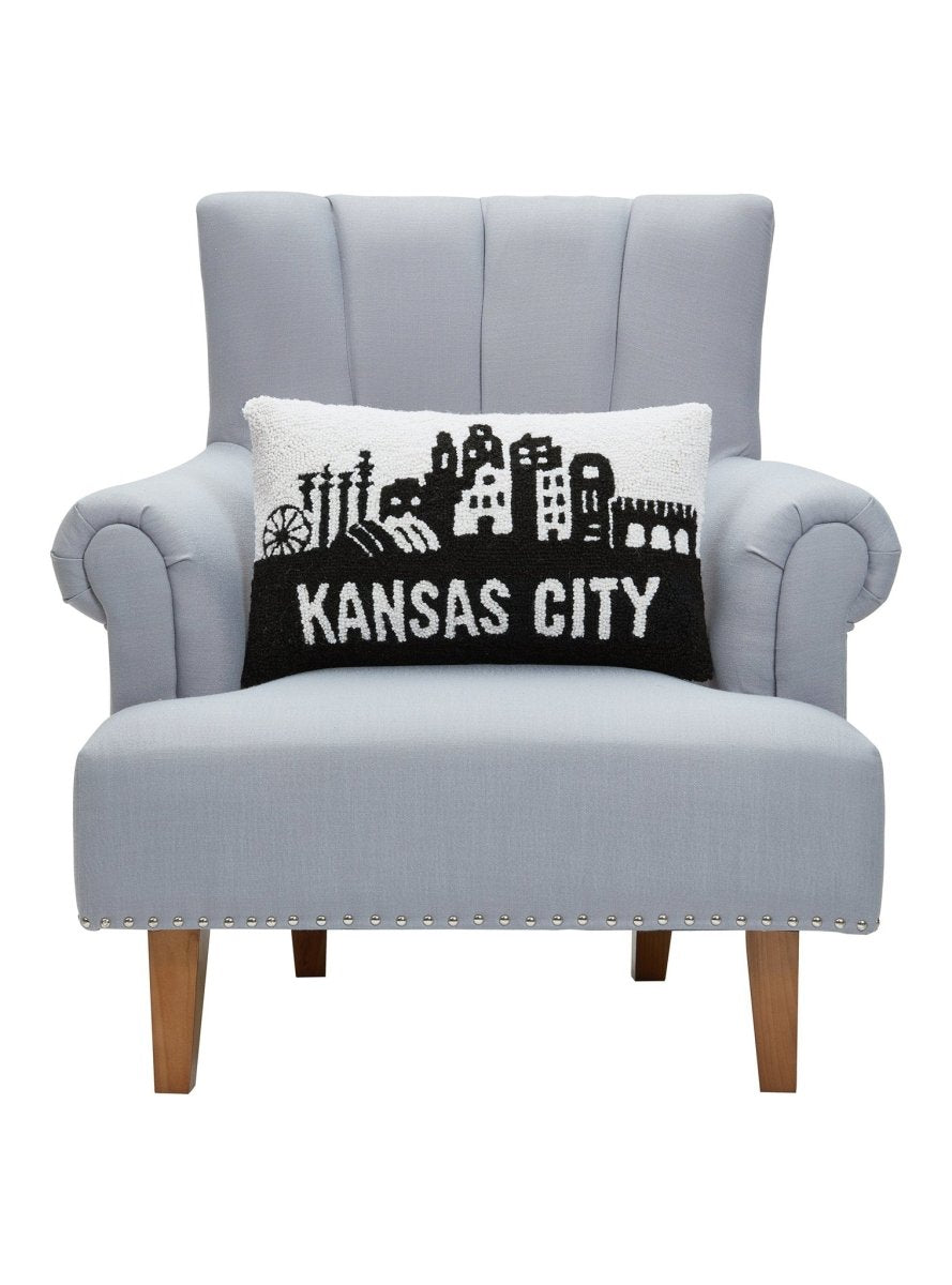 Kansas City Hooked Wool Throw Pillow on an armchair, showing the throw pillow at room scale, 12x20 inch
