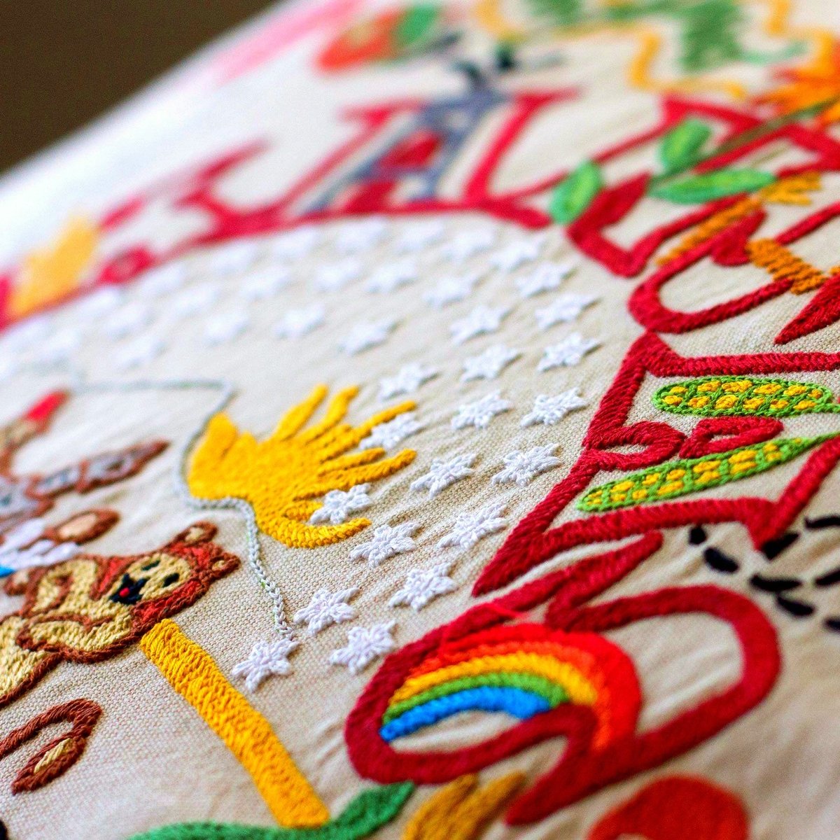 Kansas State Sunflower Embroidered Travel Throw Pillow - close-up detail of hand-embroidered needlepoint stitching